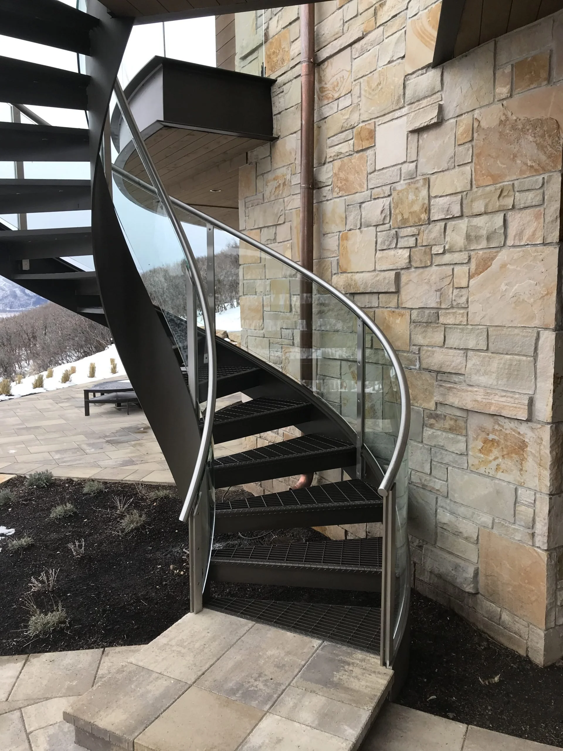 Modern exterior spiral stair with stainless hand rail