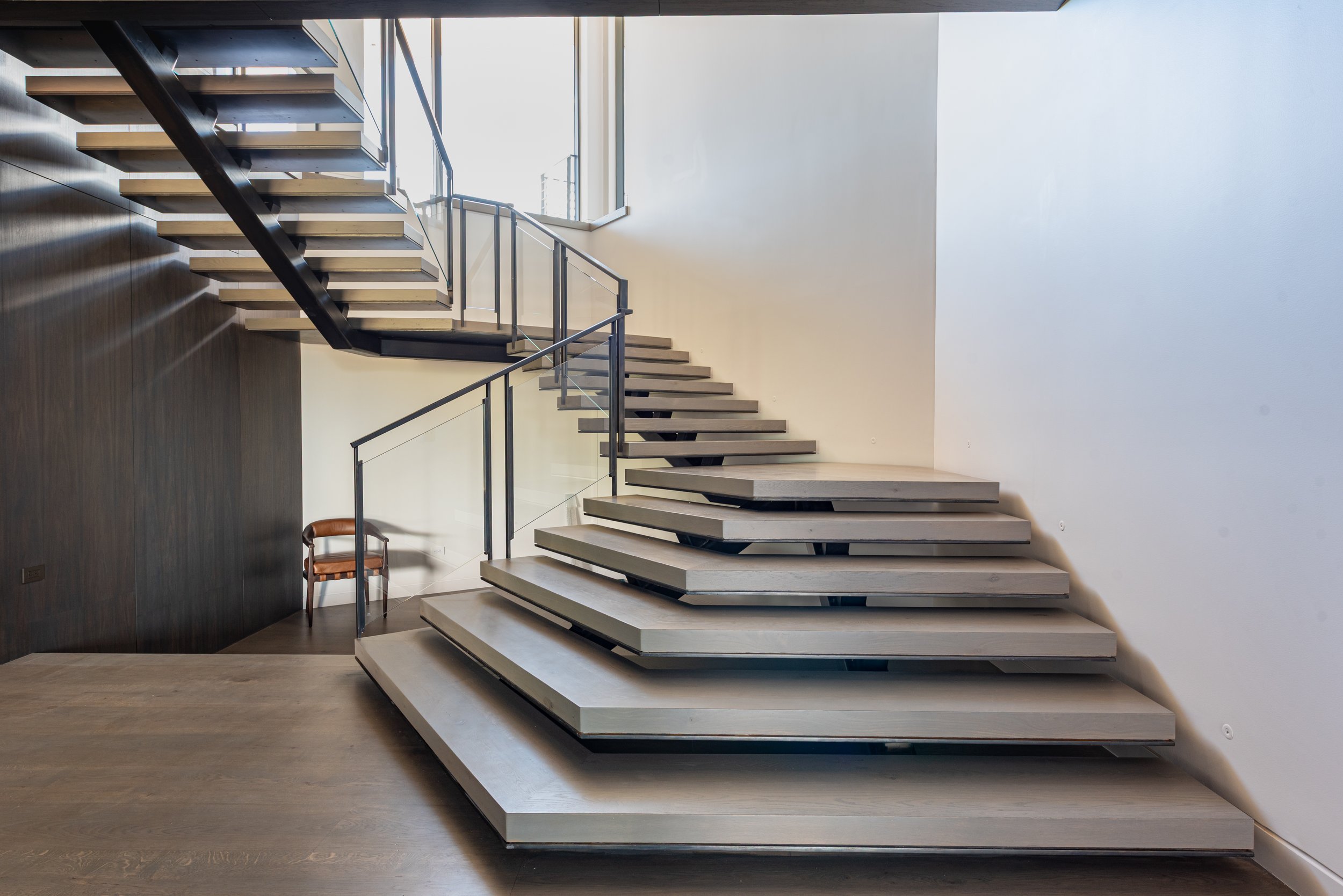 Mono stringer stair by Innovative with glass rail base
