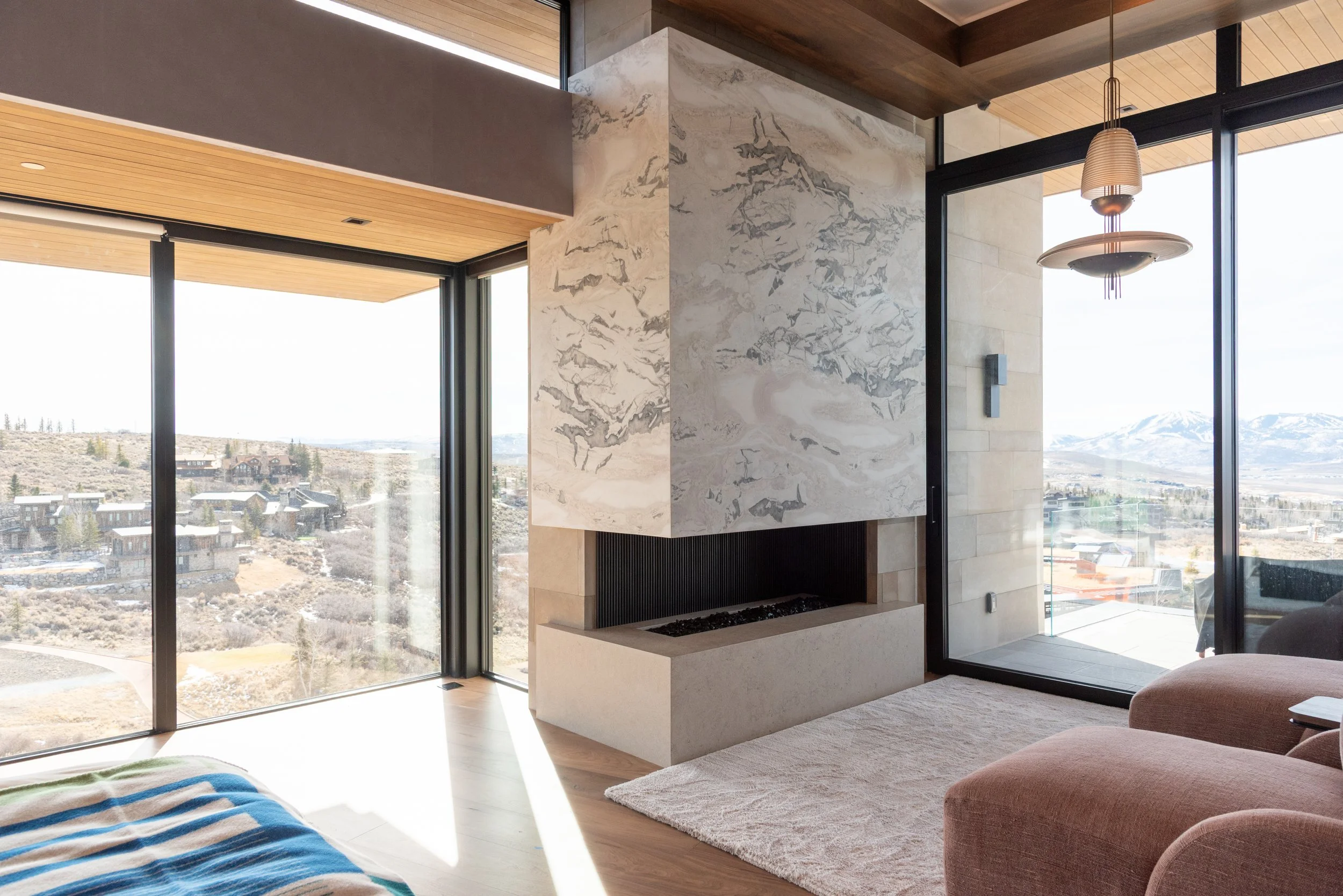 Custom steel fireplace wrapped in stone finish