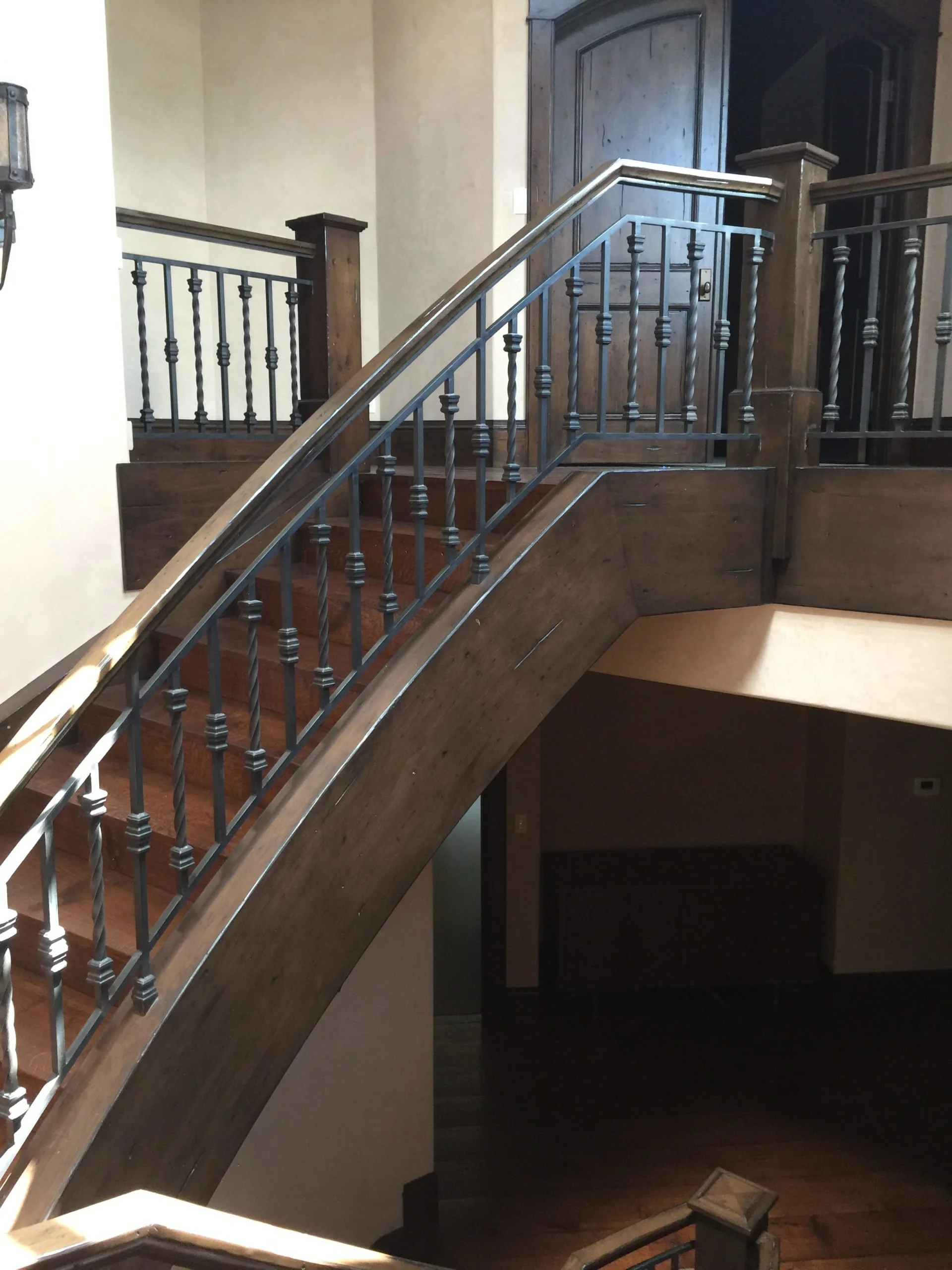 Wrought iron rail on wood clad stair