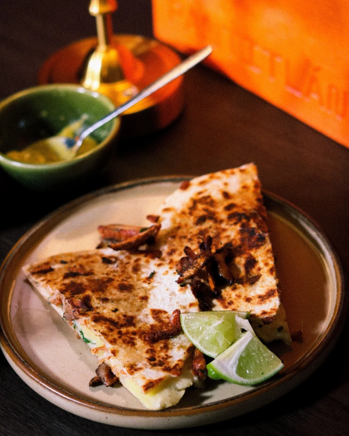 The char on a quesadilla doesn't lie.
Pressed until golden, filled with melted cheese and earthy mushrooms &mdash; this is street food done with intention.
Served with fresh lime and a side of salsa, because the details always matter.
Find your table