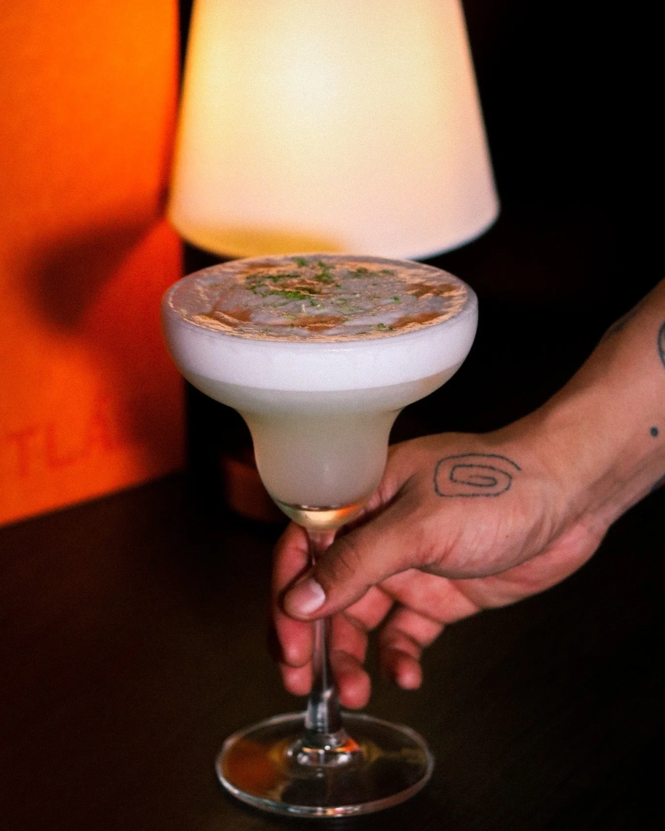 The margarita has been Mexico's most iconic export since the 1930s &mdash; but in the right hands, it becomes something else entirely.
Frothy, layered, finished with herbs under low light. This is the speakeasy version of a street classic.
Tequila's 