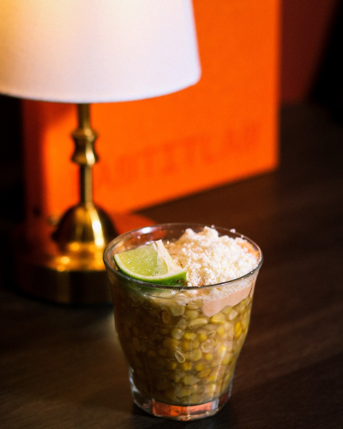 Esquites &mdash; the cup that built a thousand street corners.
Corn simmered in epazote-infused broth, topped with cotija, lime, and a little chaos.
Before it was a side dish, it was the whole meal &mdash; sold from carts at dusk across Mexico City, 
