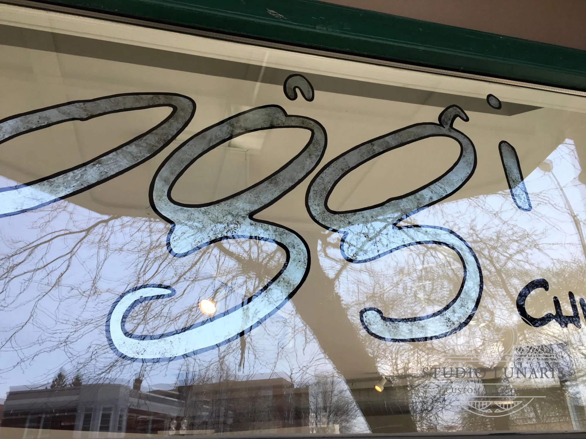 Distressed silver leaf patina business name lettering on glass doors