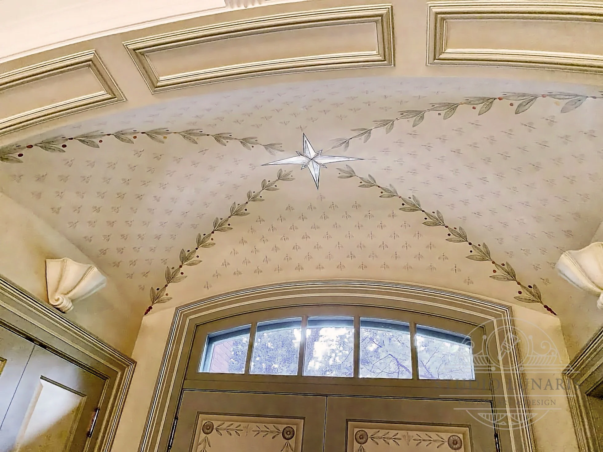 Entry foyer ceiling mural with a bee and olive leaf themed stencil pattern and a metallic star medallion.
