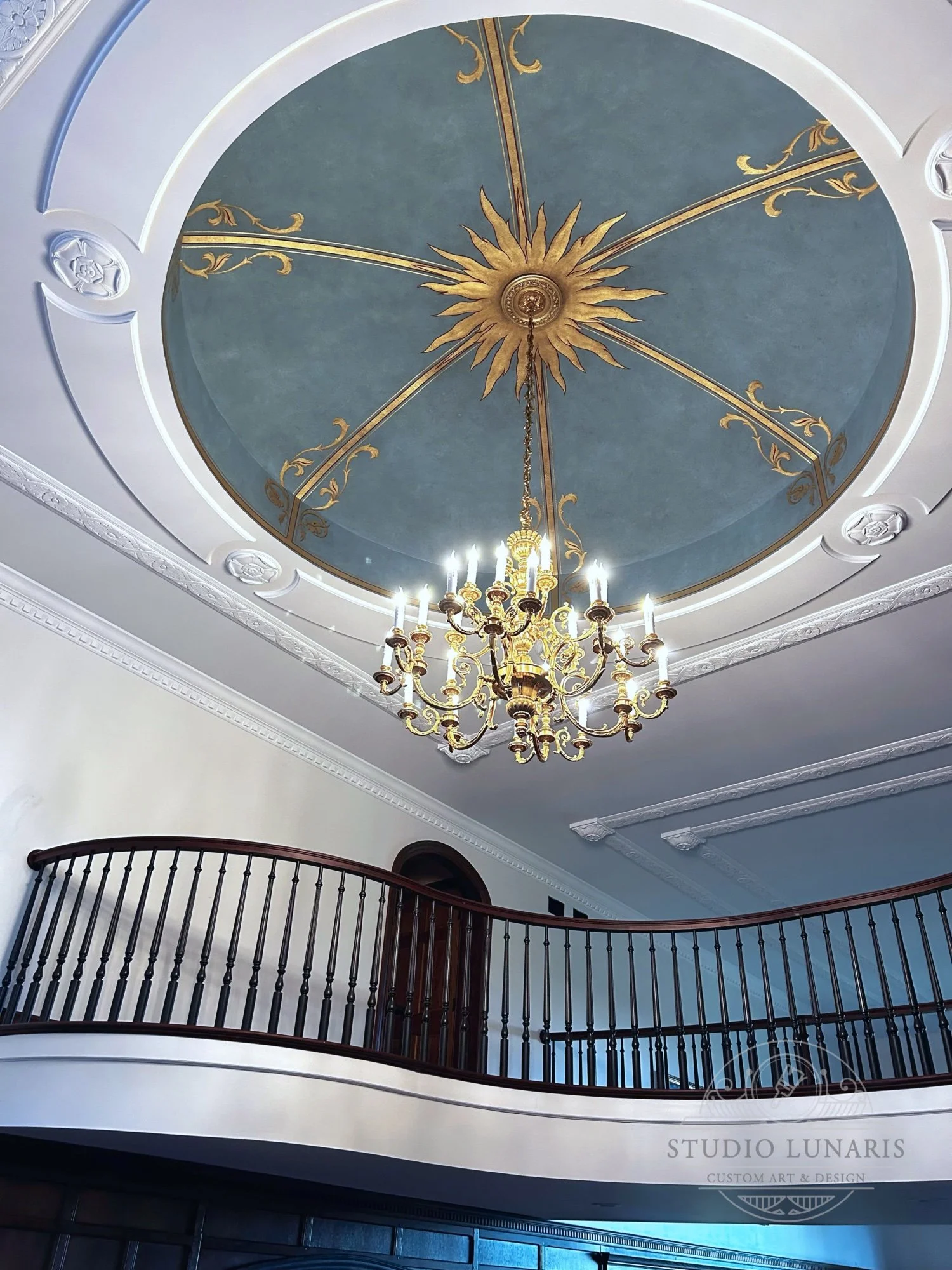 Entry foyer mural on a dome ceiling with an ornamental sun theme