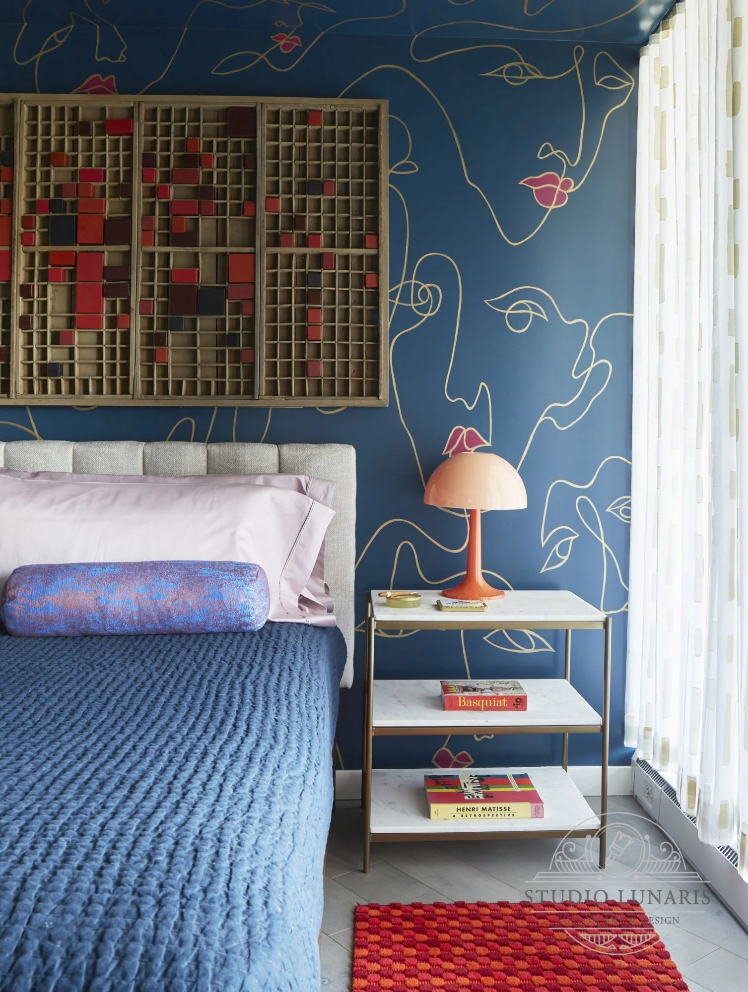 Bedroom mural with abstract faces composition. Gold linear pattern and red lip accents on a navy blue background
