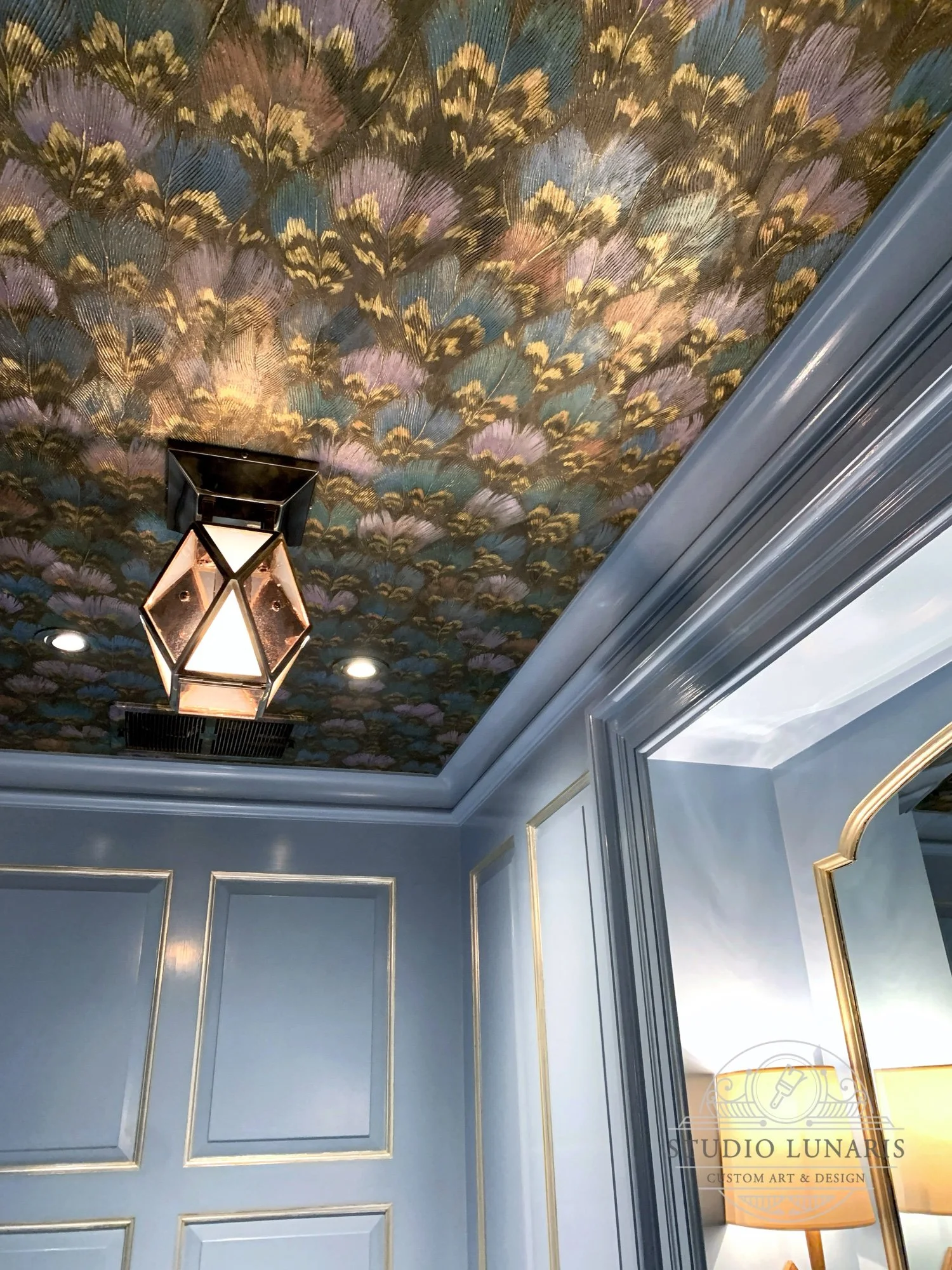 Powder room ceiling mural with faux painted peacock feathers and gold accents.