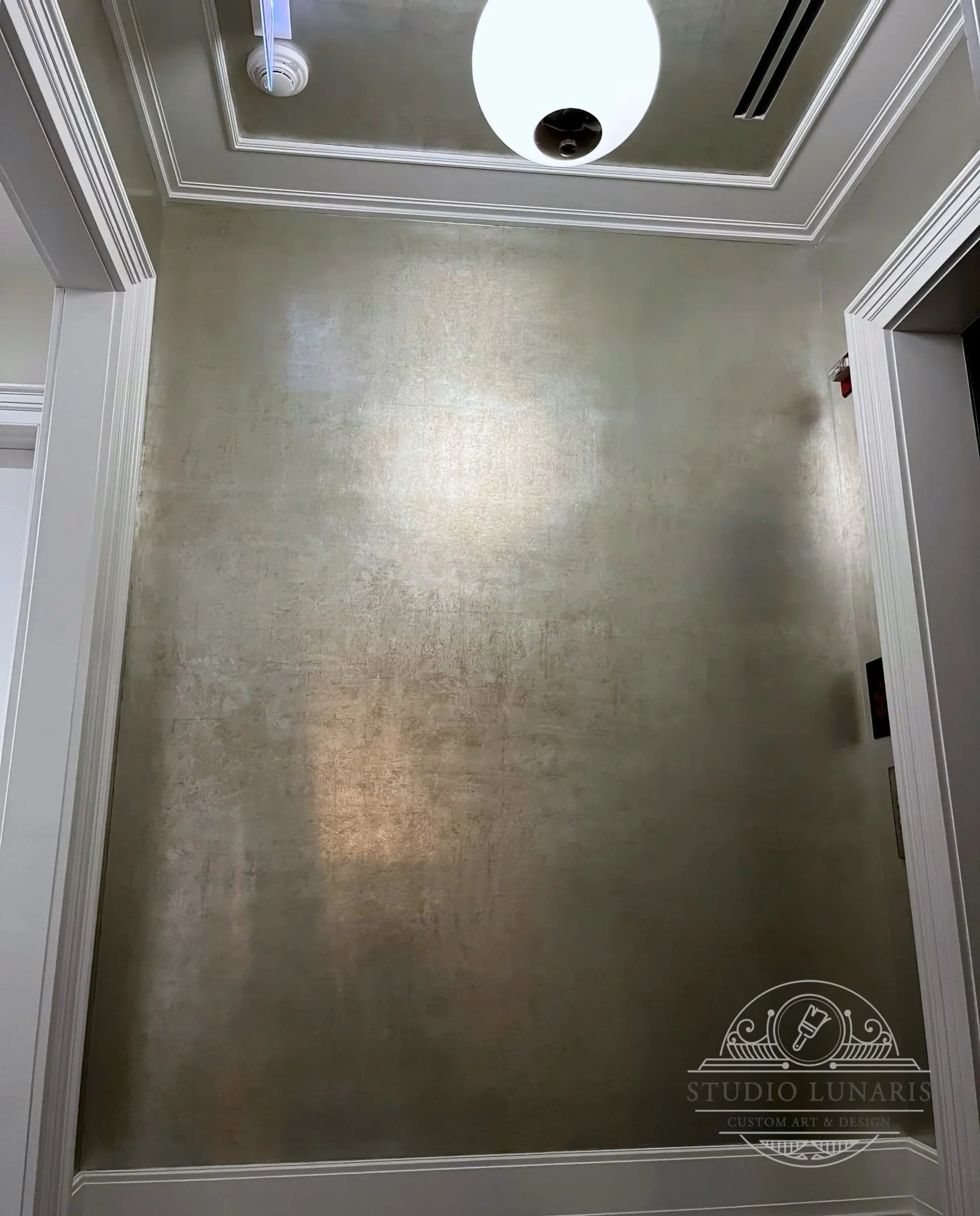 Elevator lobby silver patina walls and ceiling