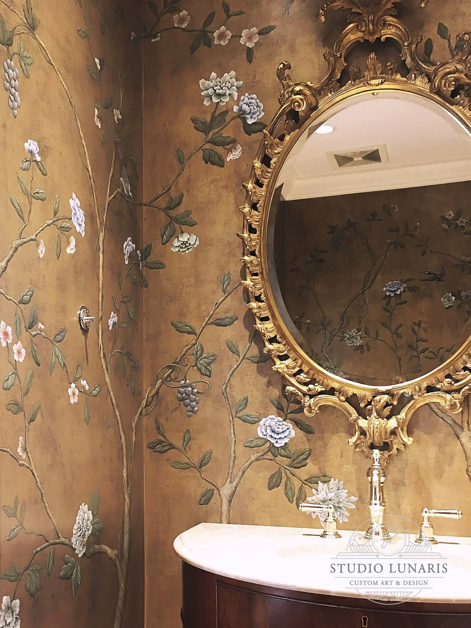 Powder room mural with a warm metallic gold background and chinoiserie floral trees scene