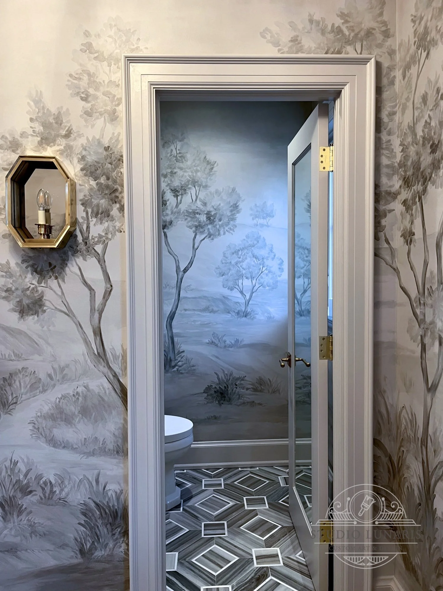 Scenic bathroom mural with a sepia toned, grisaille forest theme.