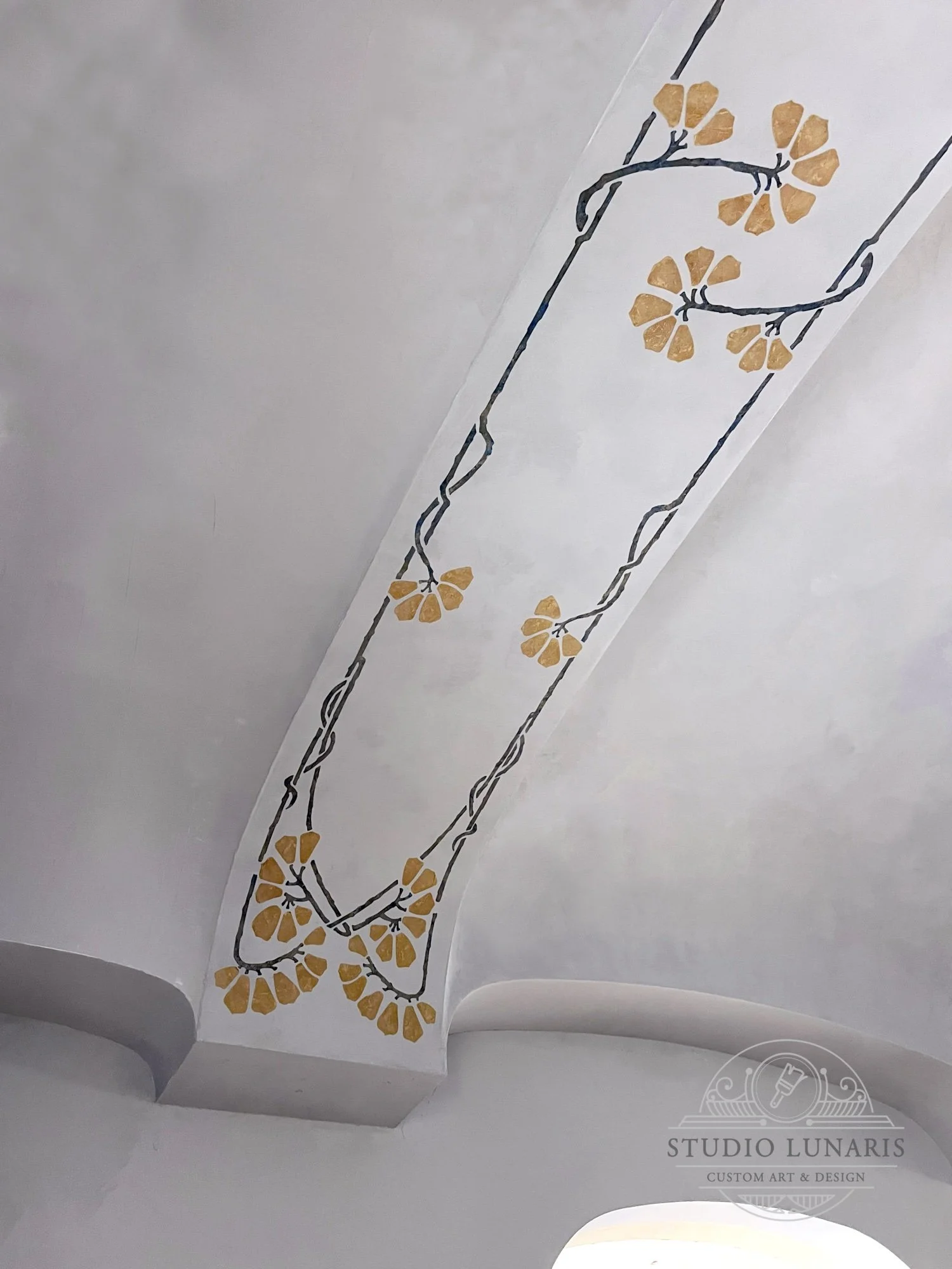 Dining room ceiling beams with an Art Nouveau inspired raised plaster stencil design over soft, blue-gray marmorino plaster