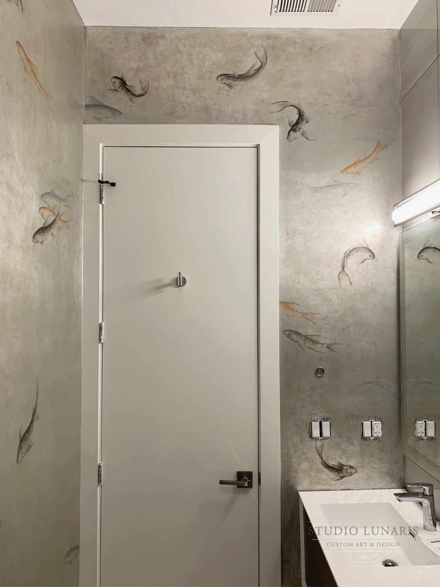Bathroom mural with silver leaf patina and playful koi fish design