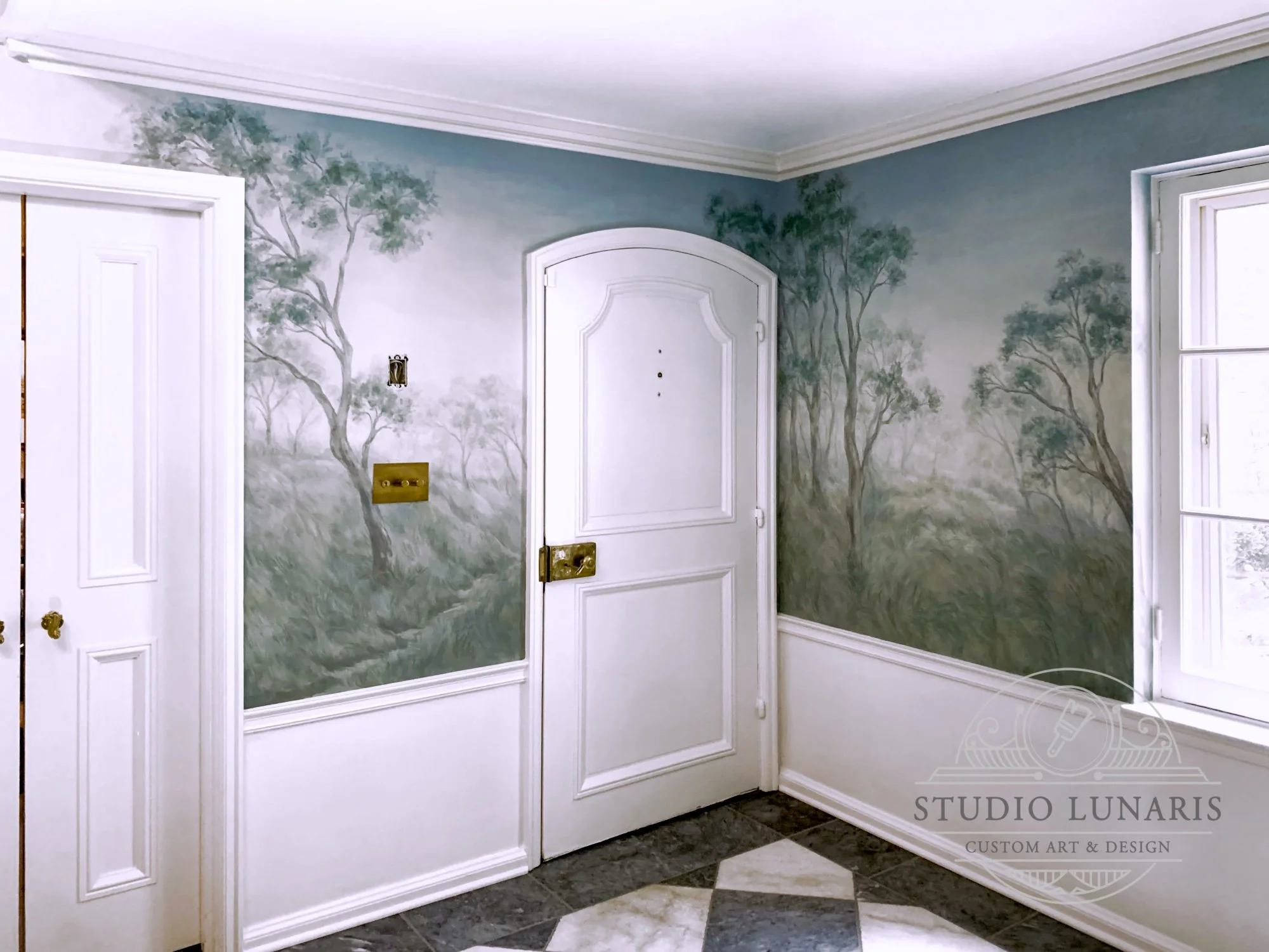 Entry foyer scenic mural in a muted color palette with a countryside theme