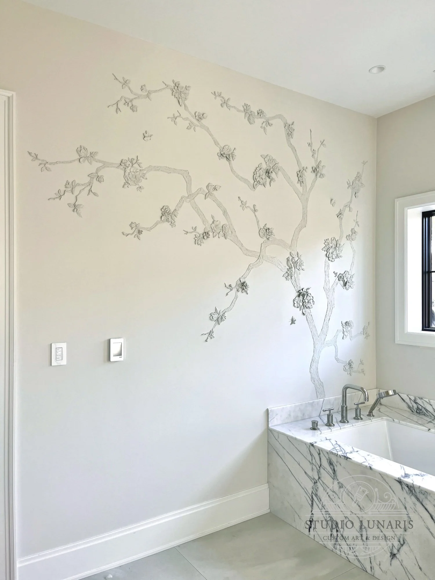 Bathroom mural with decorative plaster bas-relief tree and cast and hand-detailed floral and bird elements. 