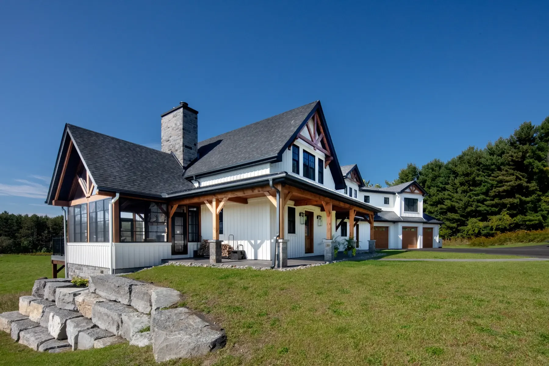 Modern-Farmhouse-Exterior-Side-View-Muskoka-Room-Normerica-Timber-Homes.webp