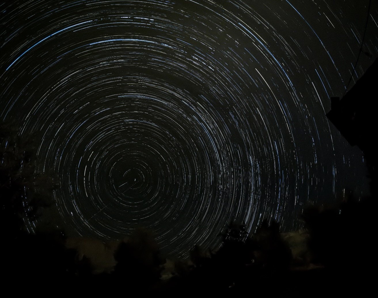 Long exposure photograph of star trails in the night sky.