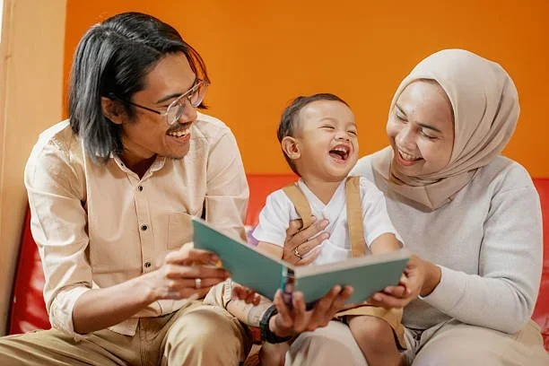 Child reading a book with parents during Speech Language Therapy with Little Ears, Big Voices