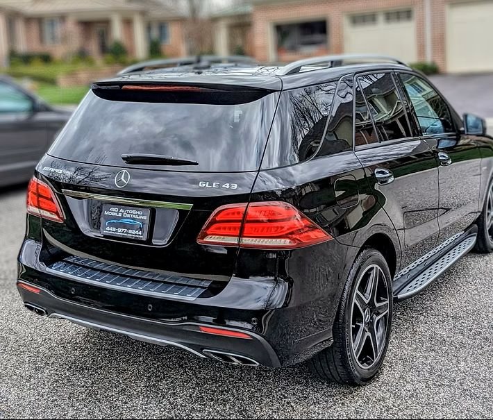 Professional mobile detailing - black Mercedes AMG SUV showcasing the depth and clarity of an Exterior Paint Enhancement service.