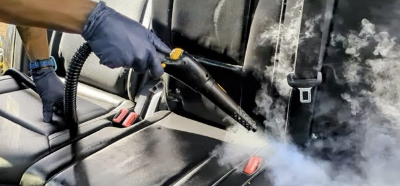 Professional mobile detailing in Maryland - high-temperature steam cleaning on vehicle upholstery during The Signature Interior service.