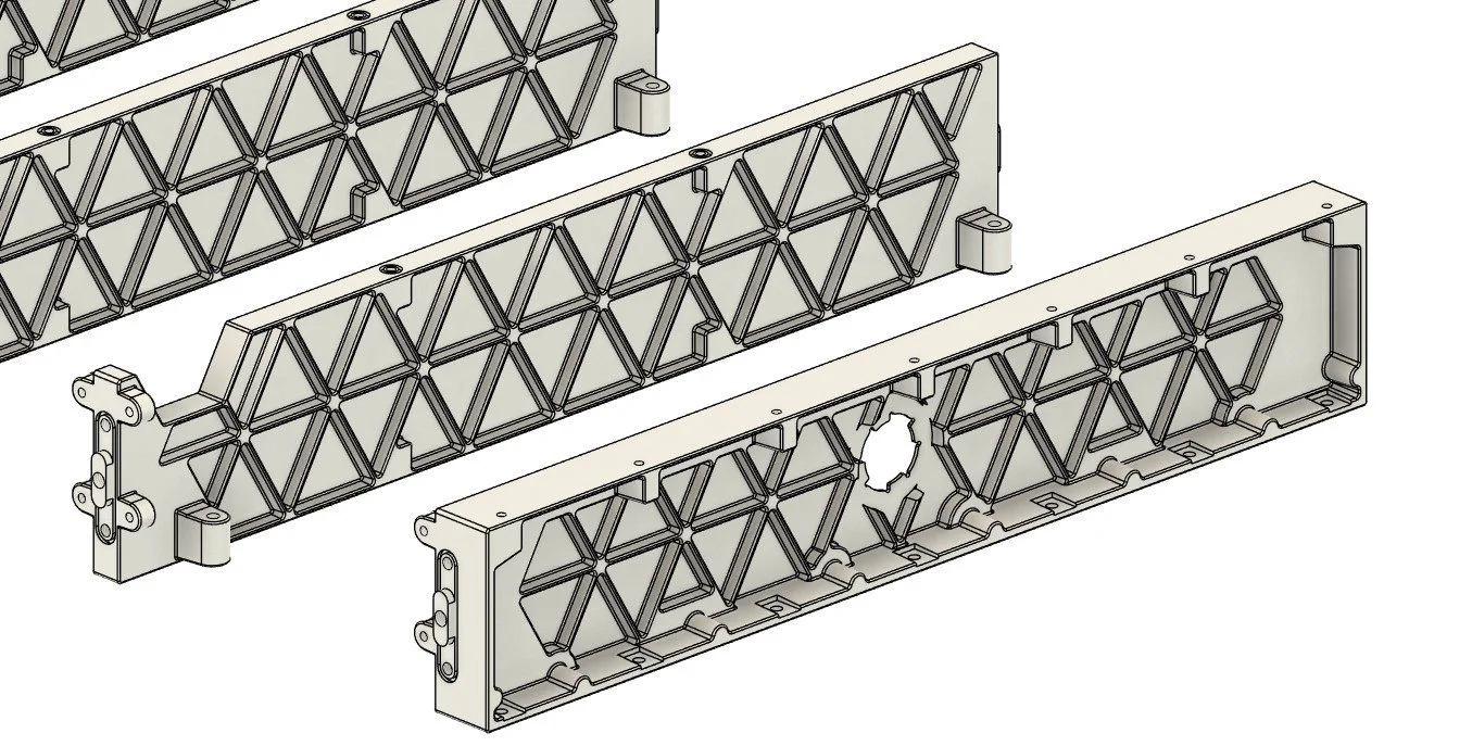 Technical drawing of three elongated, rectangular metal molds with intricate geometric patterns, including a central hole in one, used for manufacturing or casting objects.