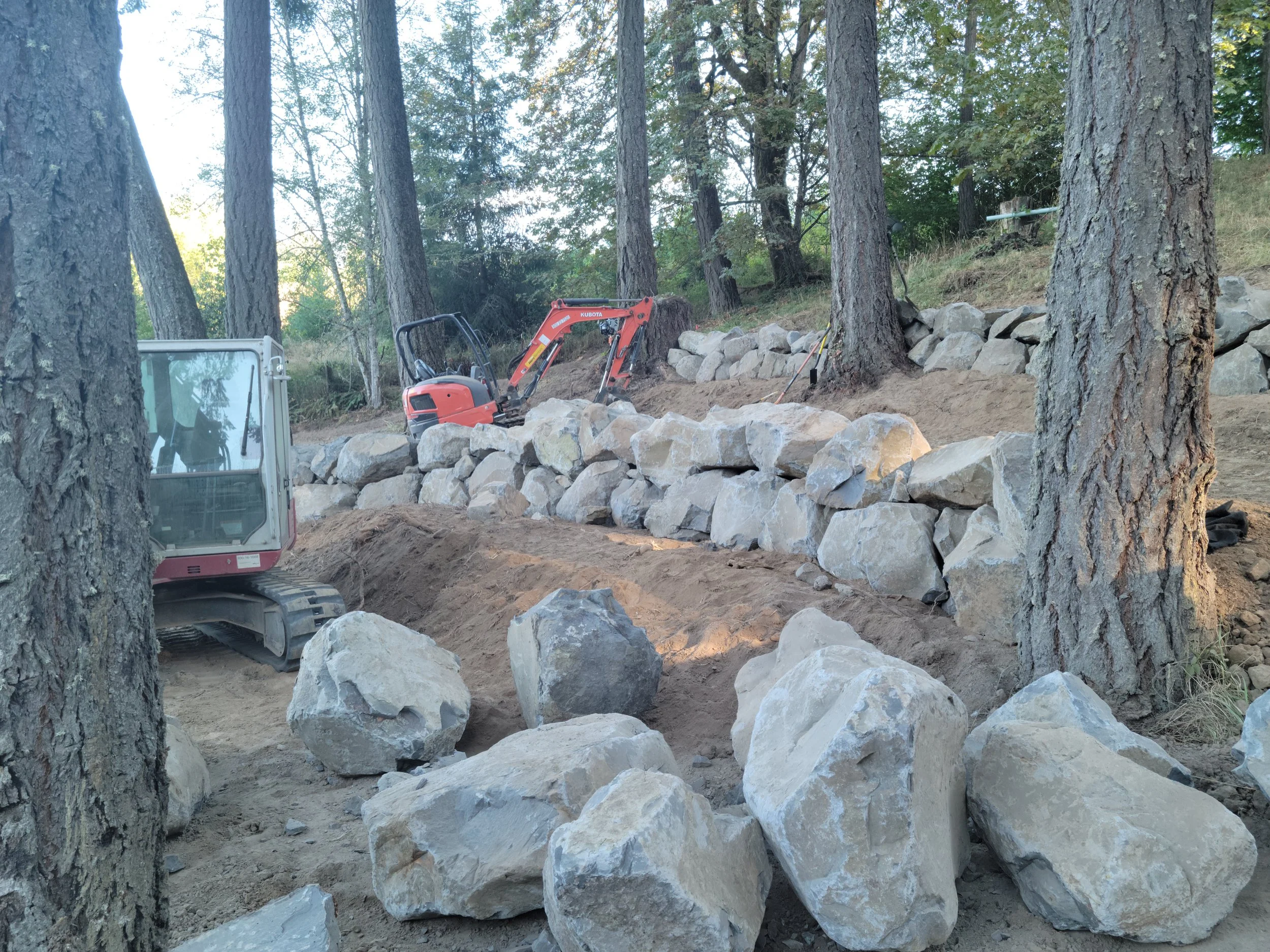 Rock or boulder retaining wall excavation