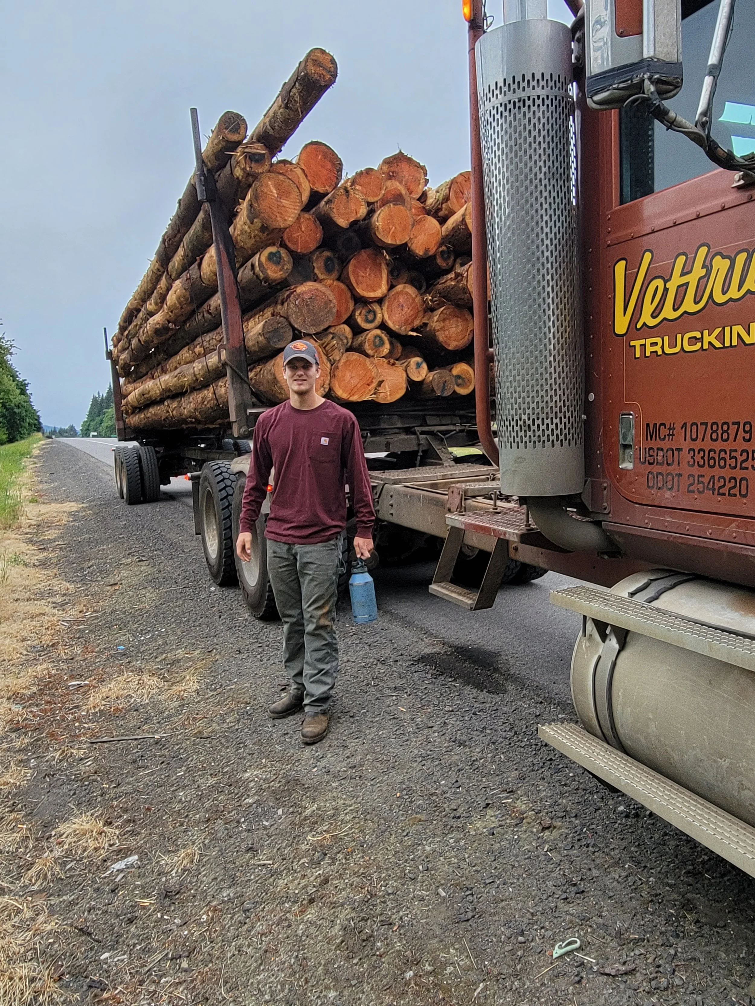 Jackson next to his Family companies Log truck Vettrus trucking.