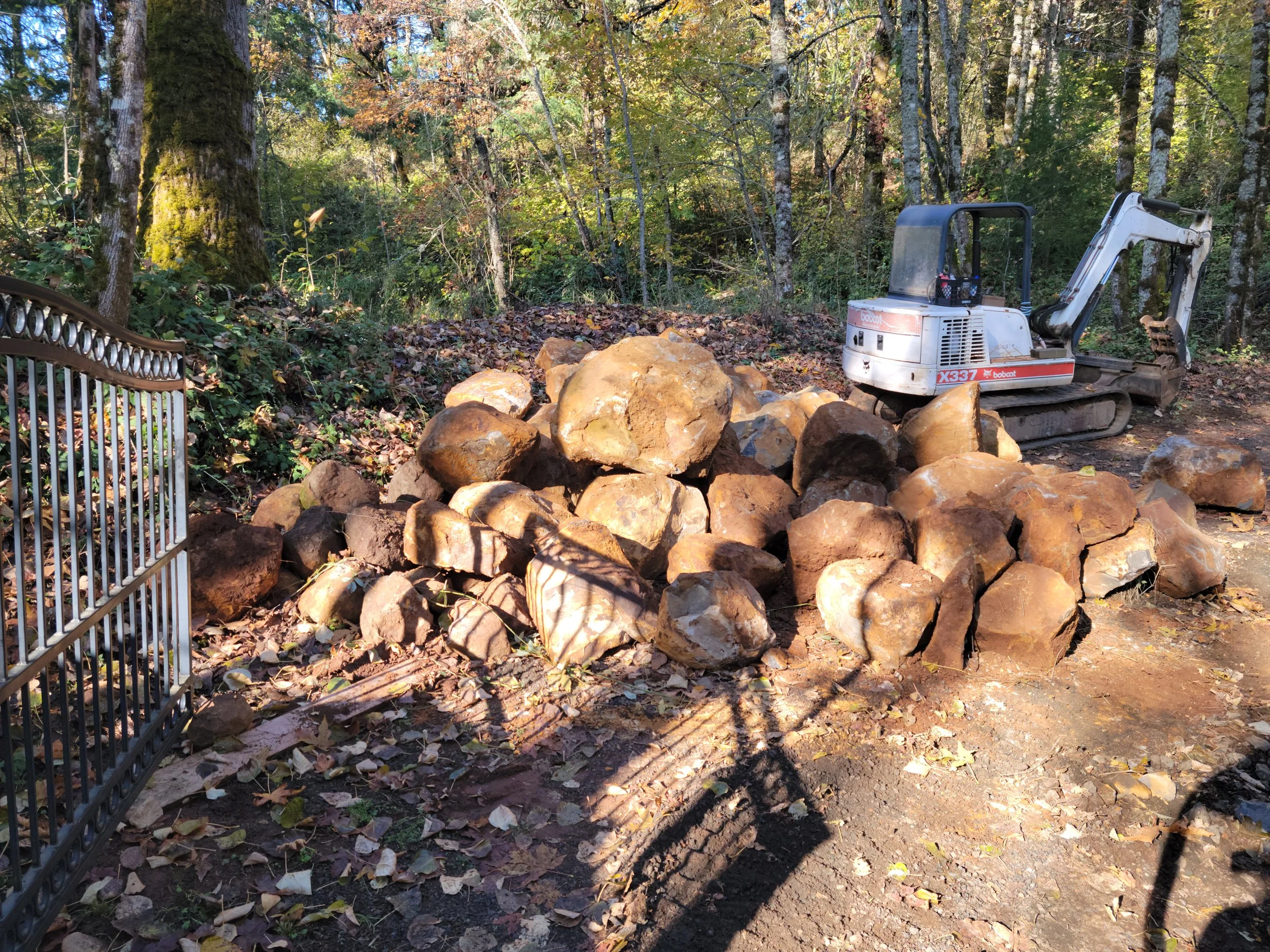 Boulders staged for new retaining wall construction West Salem.