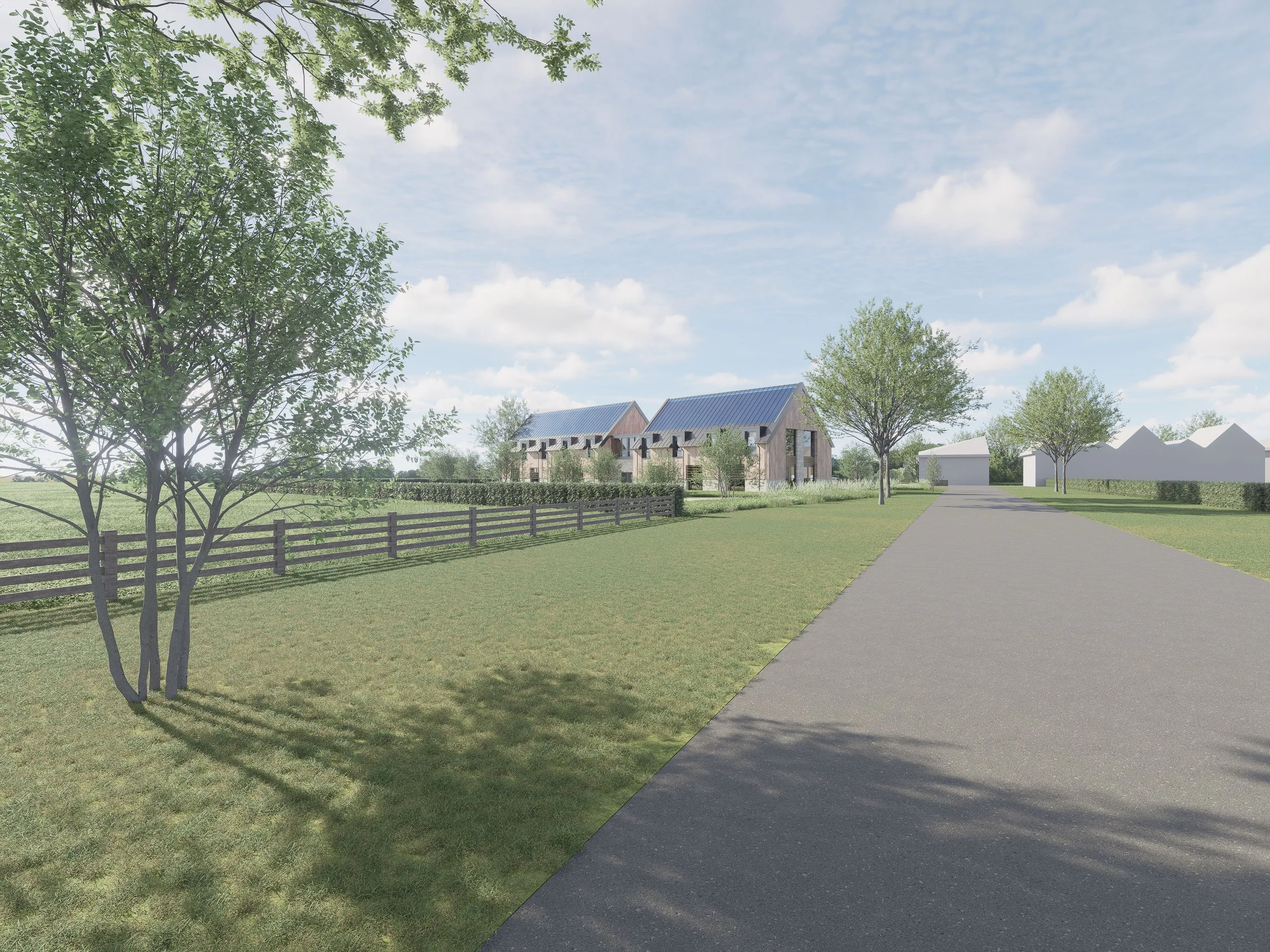 A rural scene with a paved road, green grassy areas, and trees with fresh green leaves showing Prestwick Park's countryside location.