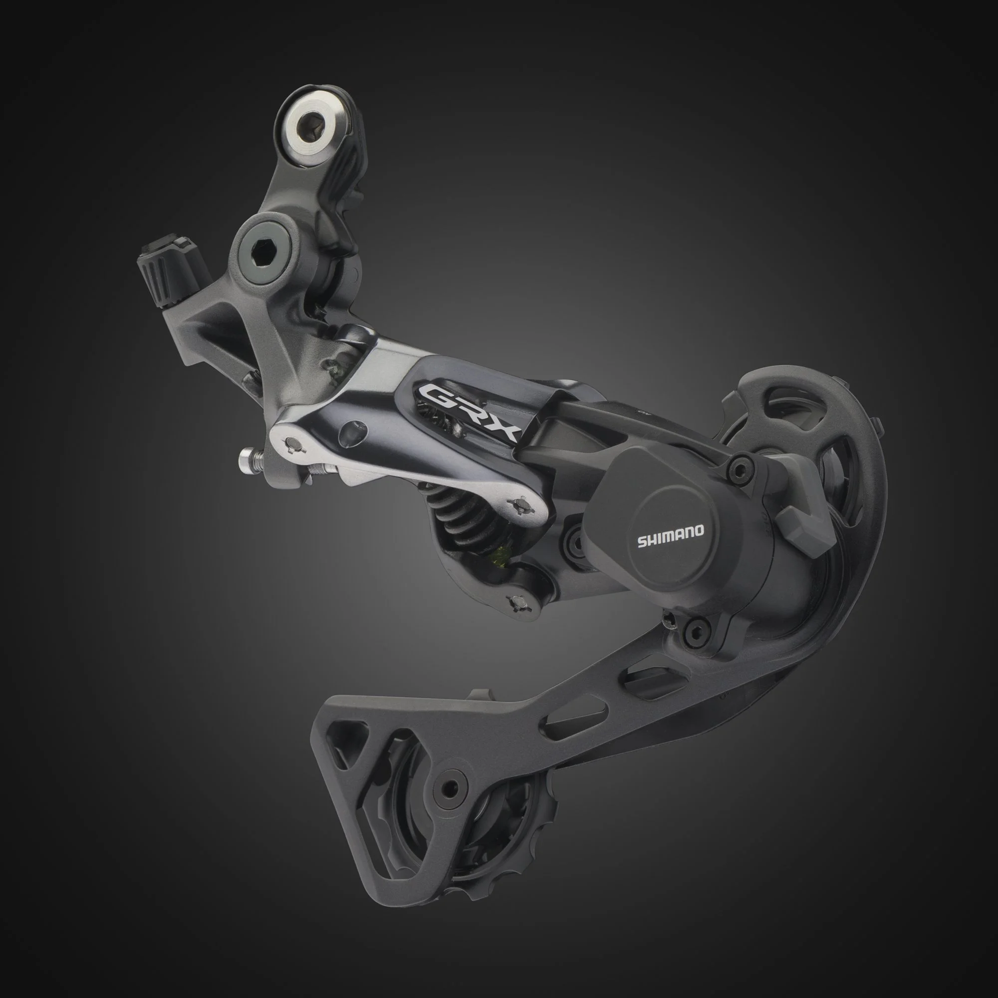 Close-up of a Shimano bike derailleur in a dark background.