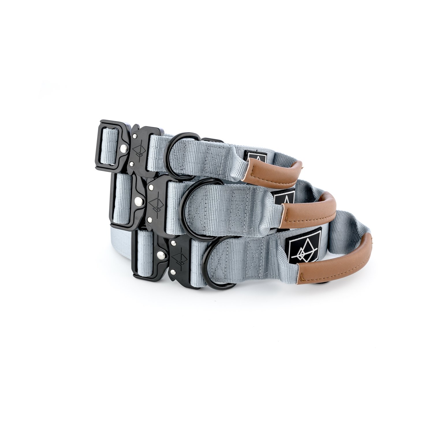 Three gray dog collars with brown leather accents and black metal hardware stacked together.
