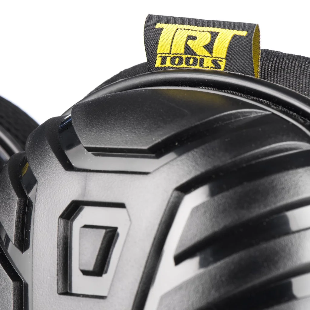 Close-up of a black construction helmet with a yellow and black Everlast patch on top.