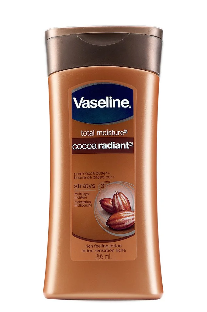 A bottle of Vaseline cocoa radiance total moisture lotion with pure cocoa butter, featuring an image of cocoa beans on the front.