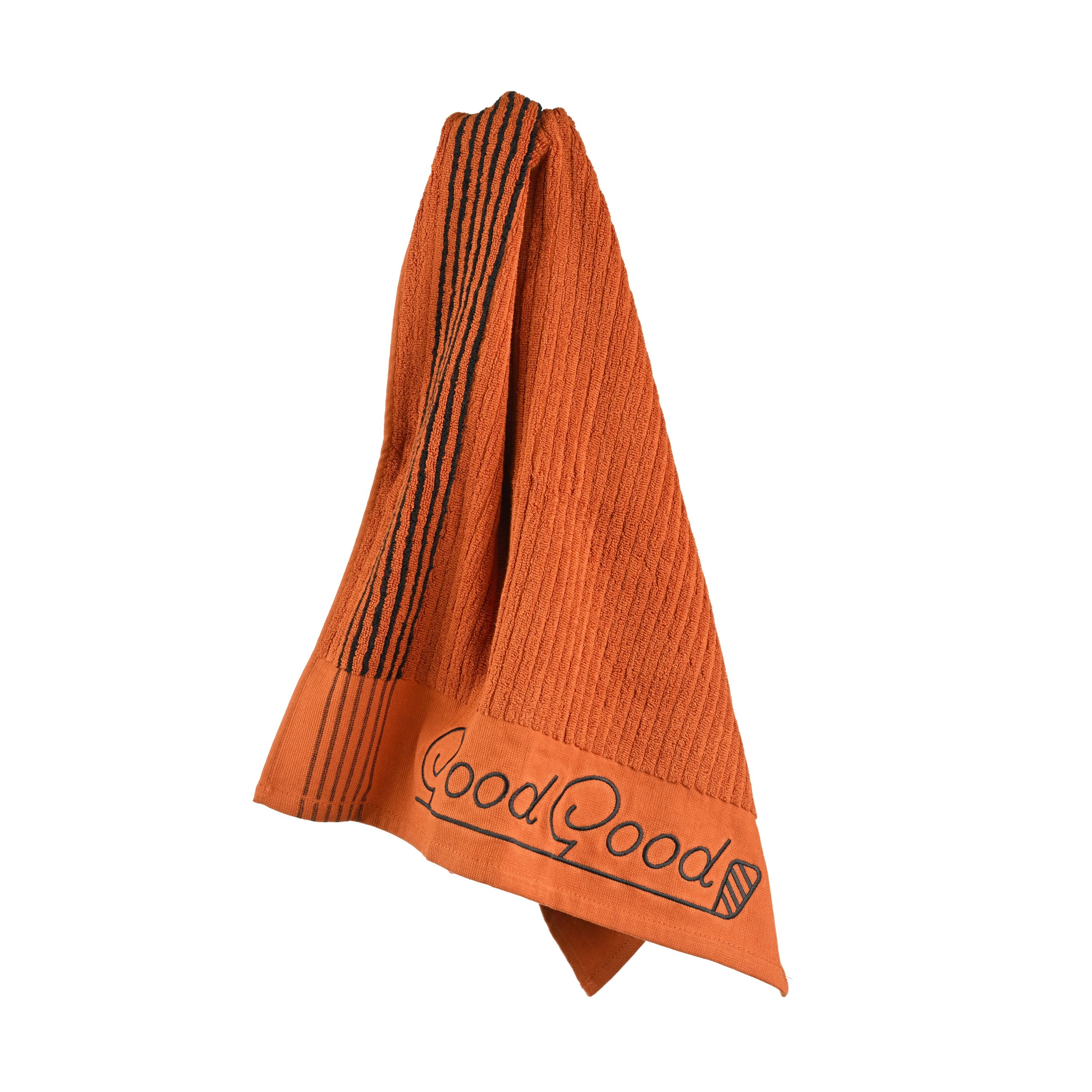 An orange kitchen towel with black stripes hanging on a hook, with 'Good Good' written at the bottom.