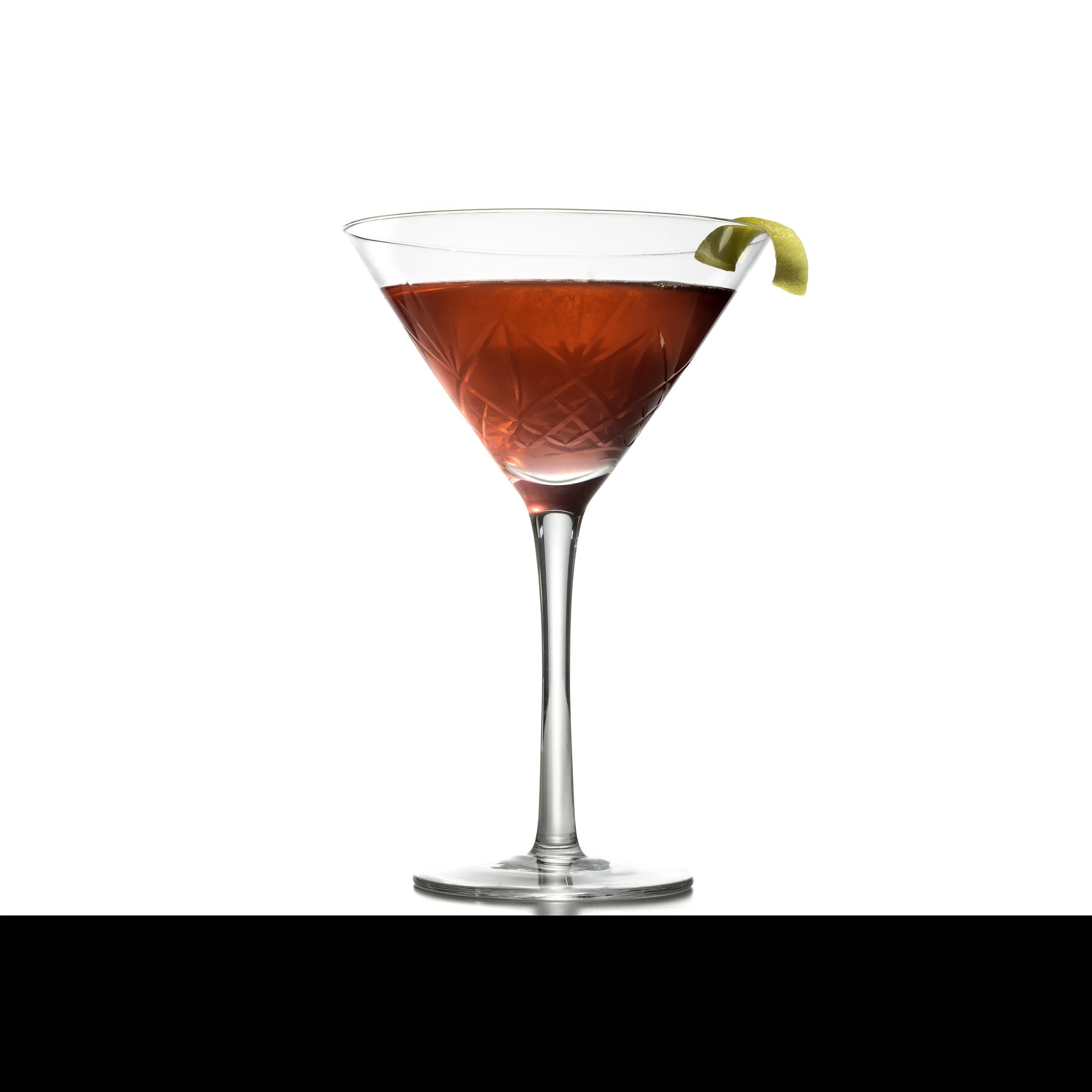 A martini glass filled with a red cocktail garnished with a lemon twist