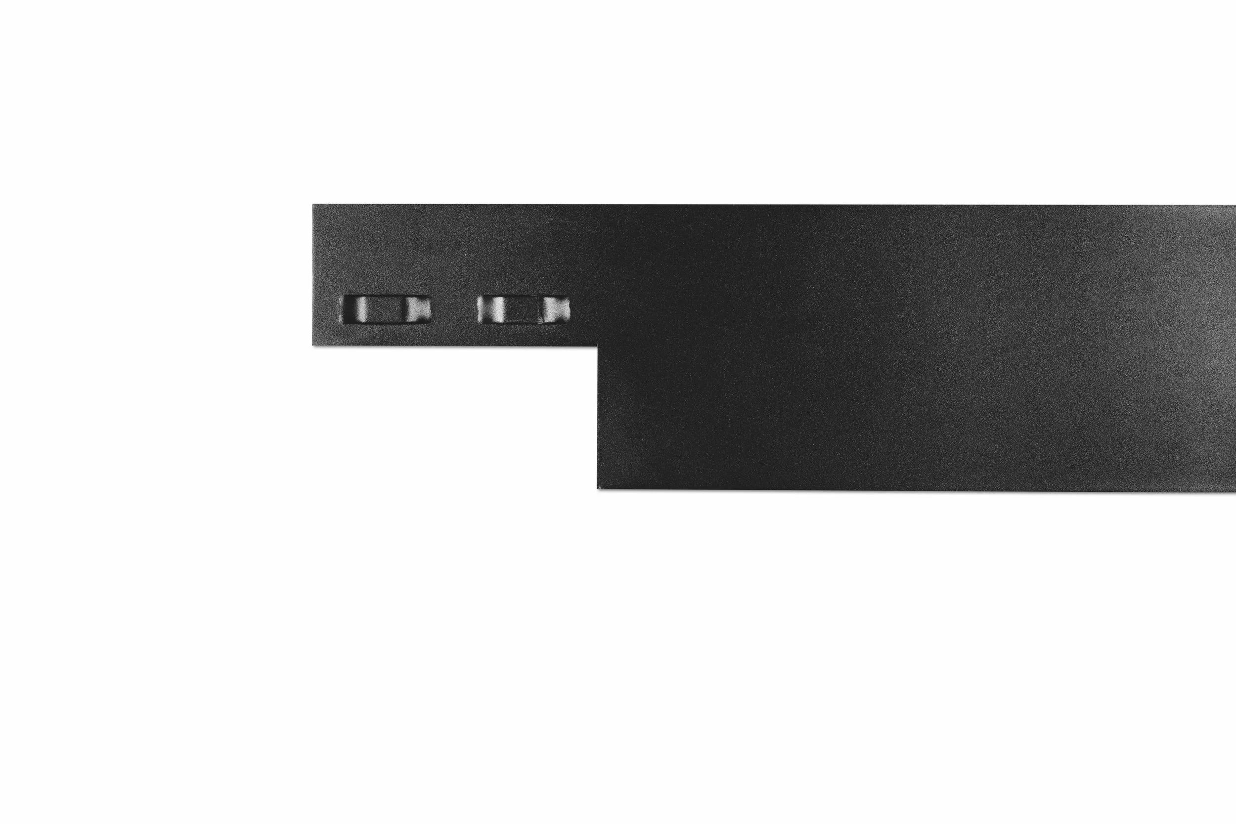 Black rectangular device with two small switches on the edge