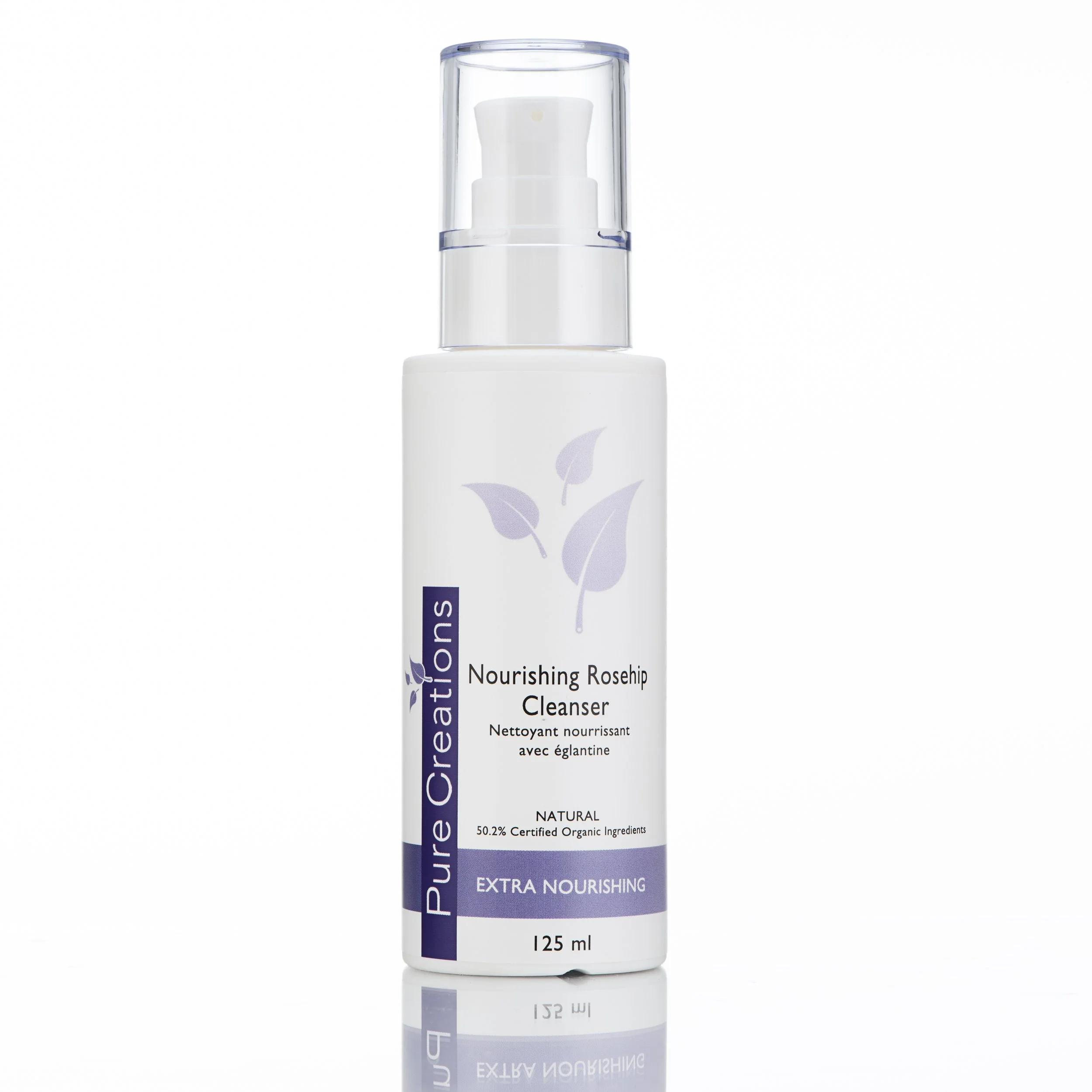 A white bottle of nourishing rosehip cleanser with purple label and matching purple accents, featuring a clear pump dispenser and a leaf graphic, standing on a reflective surface.