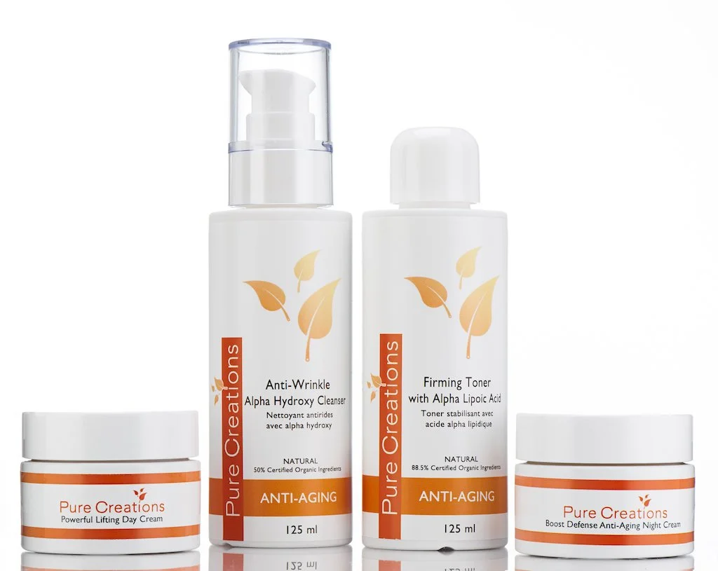 Set of four skincare products from Pure Creations with anti-aging and organic ingredients, including a lifting day cream, anti-wrinkle cleanser, firming toner, and night cream.