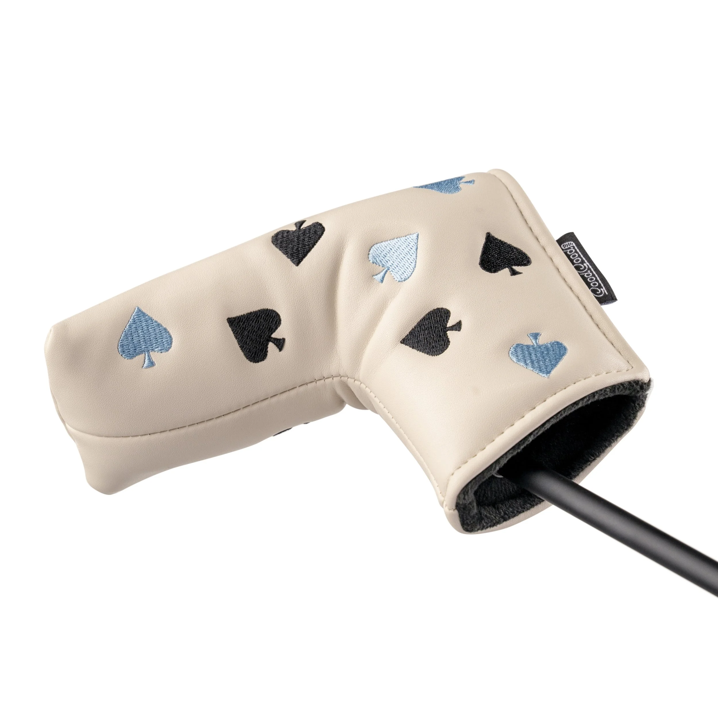 Golf club with a beige headcover decorated with black and blue spade symbols.
