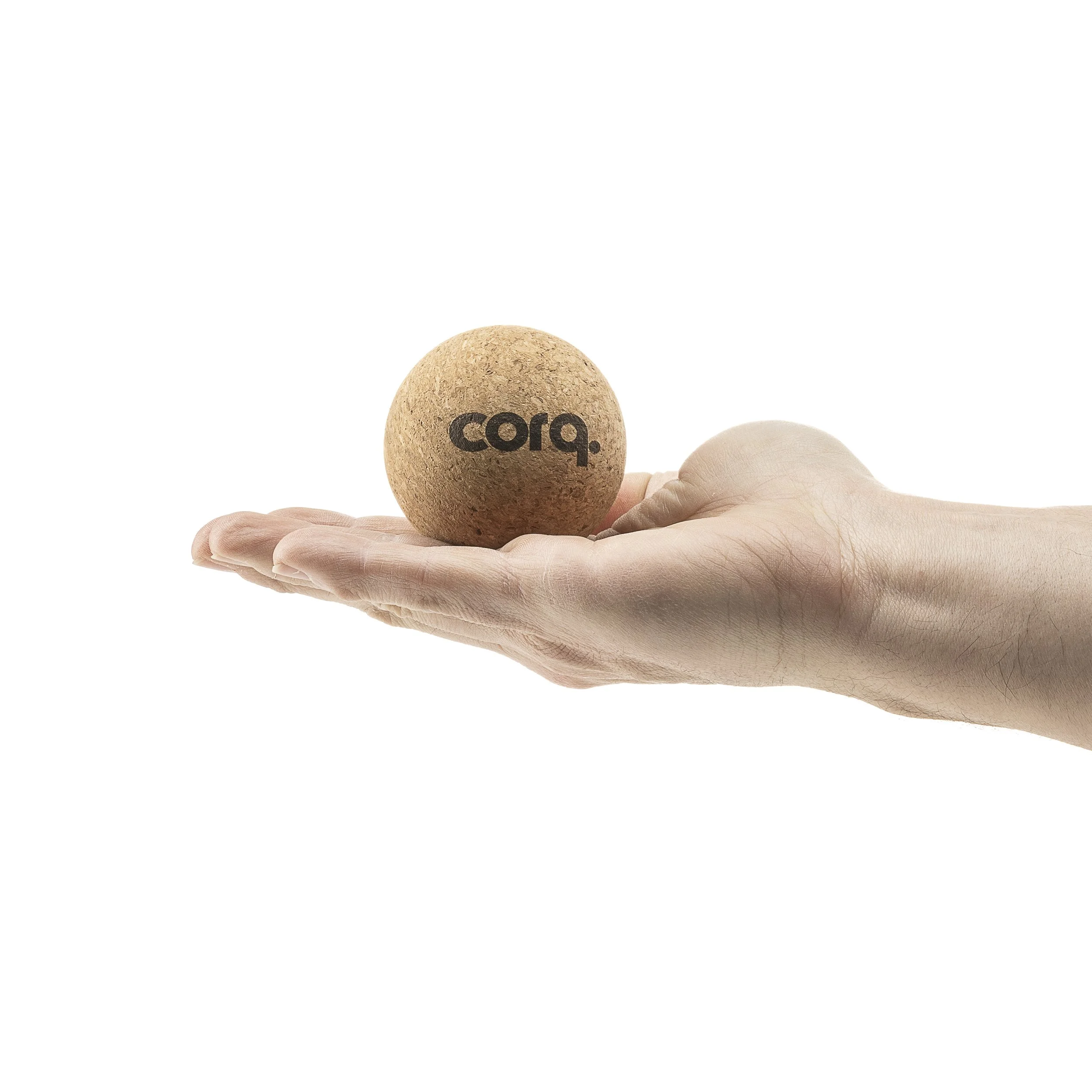 A human hand holding a round cork ball with the word 'corq.' printed on it in black.