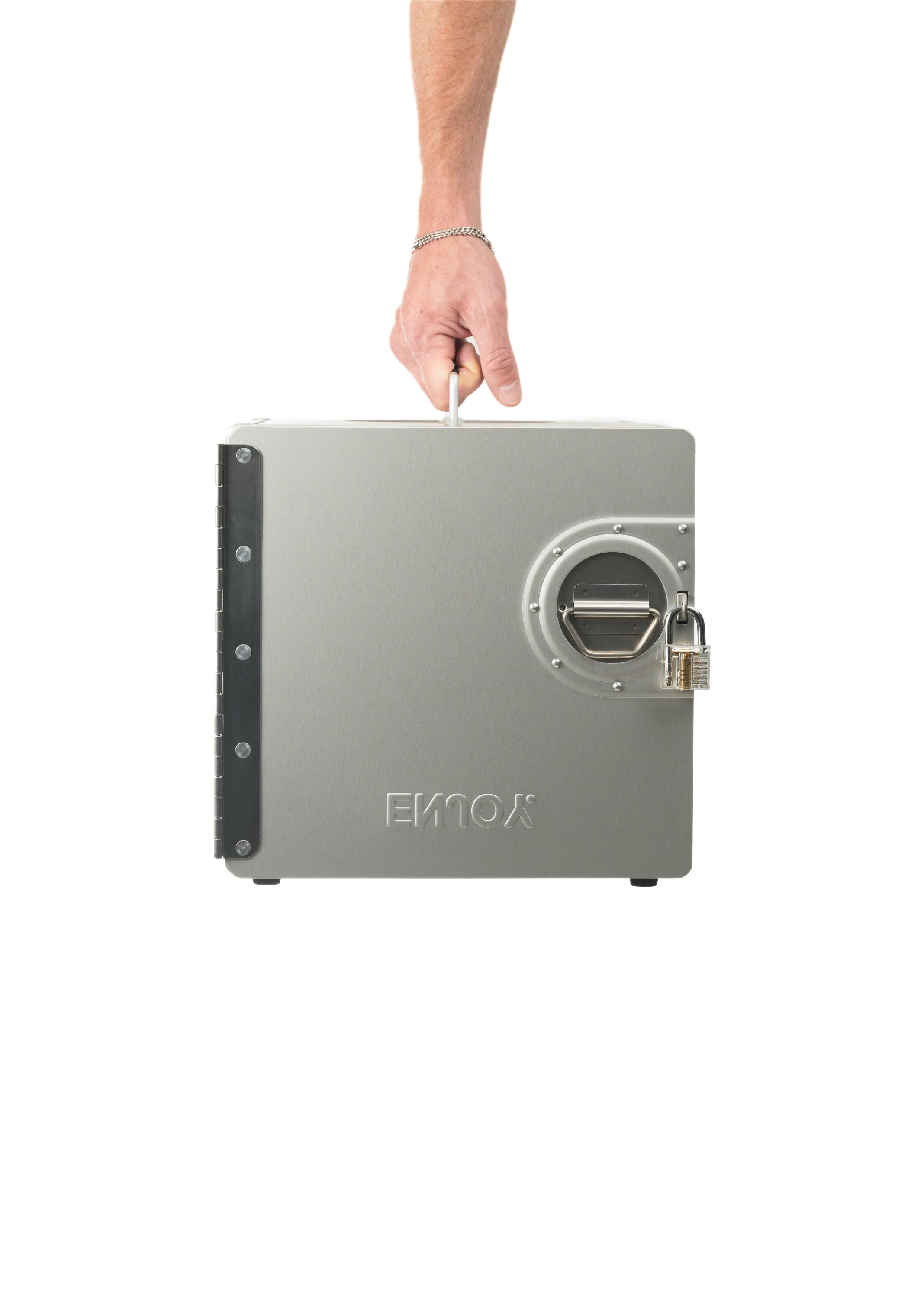 A person placing a key into a gray, secure, metal box with a padlock and a circular latch, isolated on a white background.