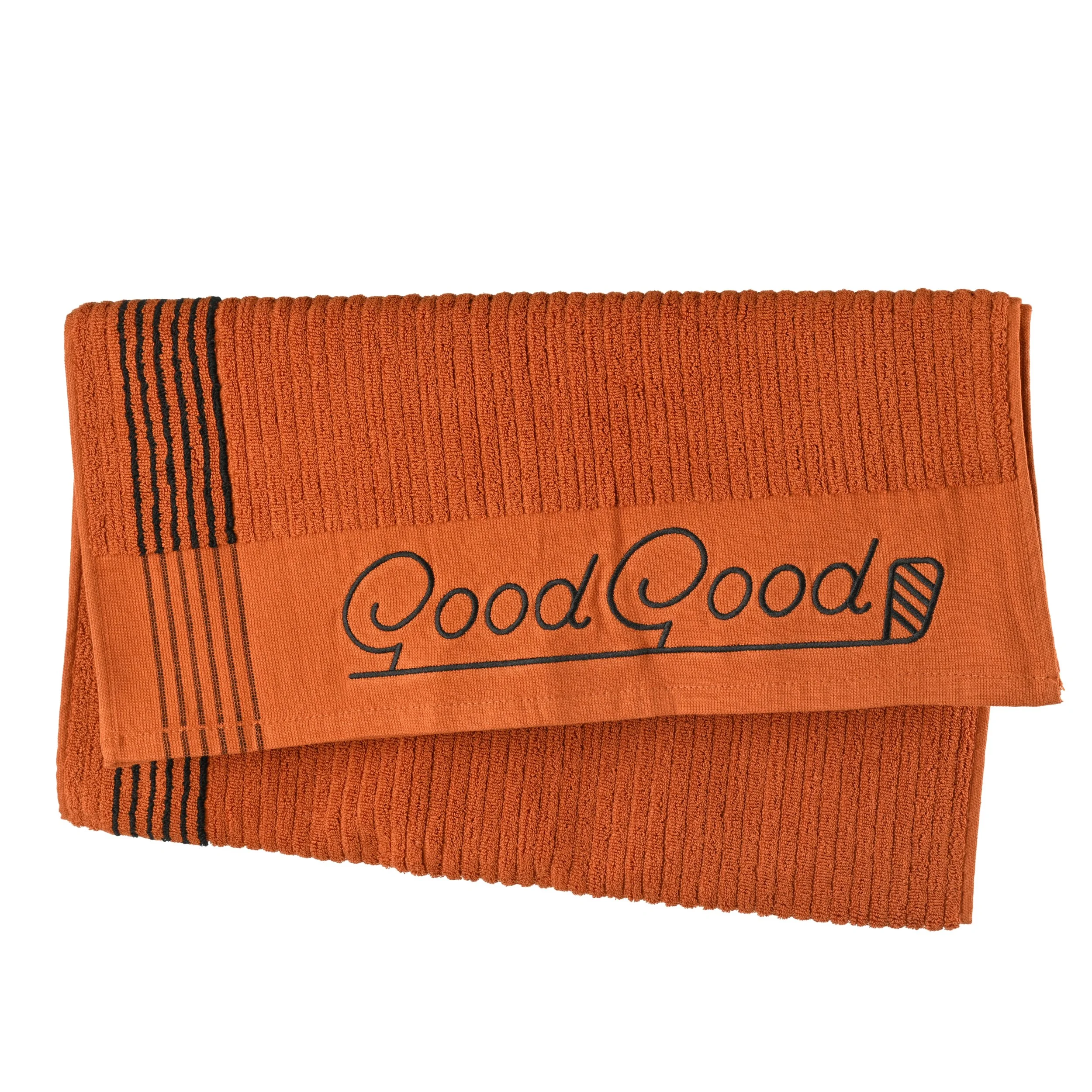 Orange towel with black stripe details and the words "Good Good" embroidered on it.