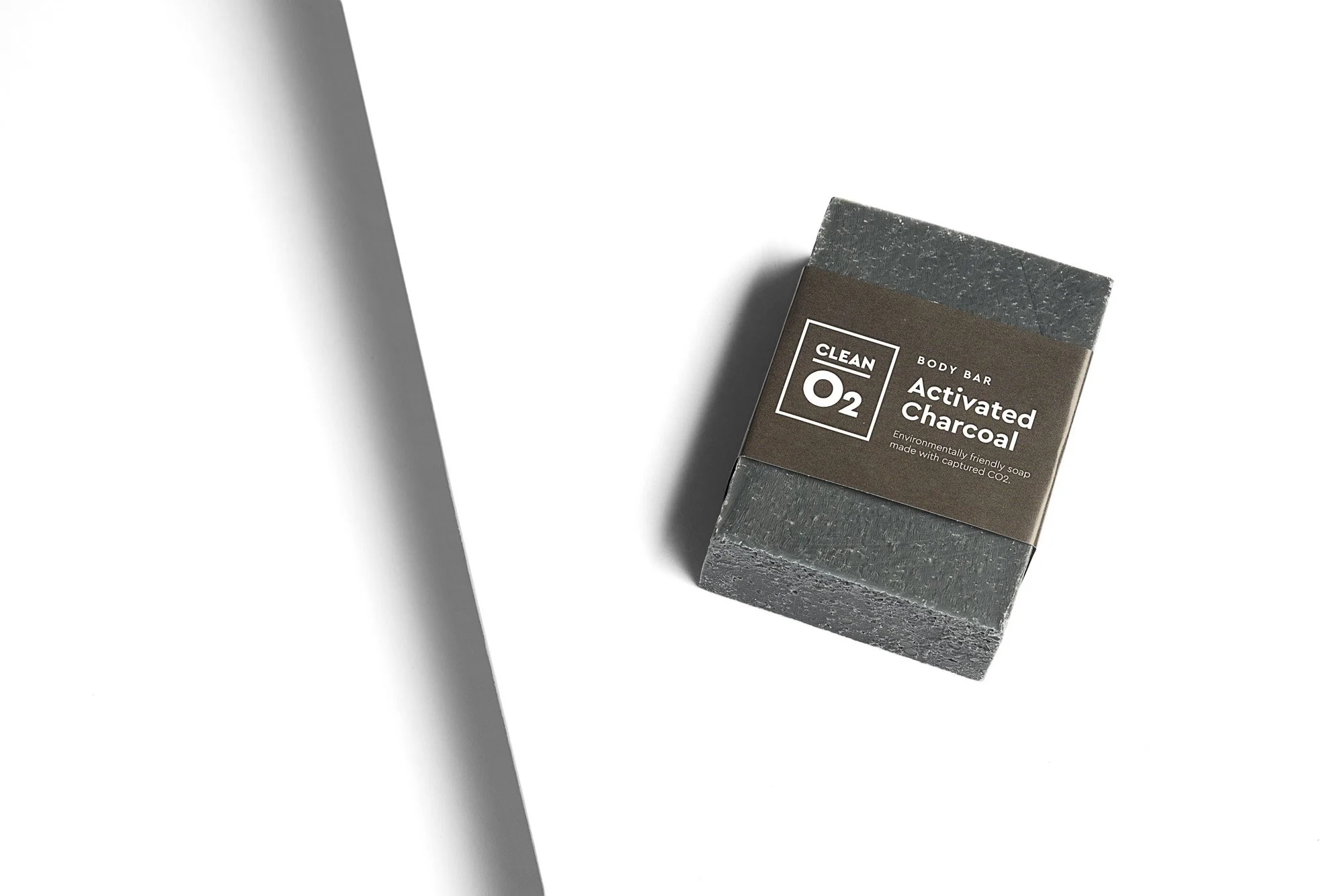 A bar of activated charcoal soap labeled 'CLEAN 02' on a white background.