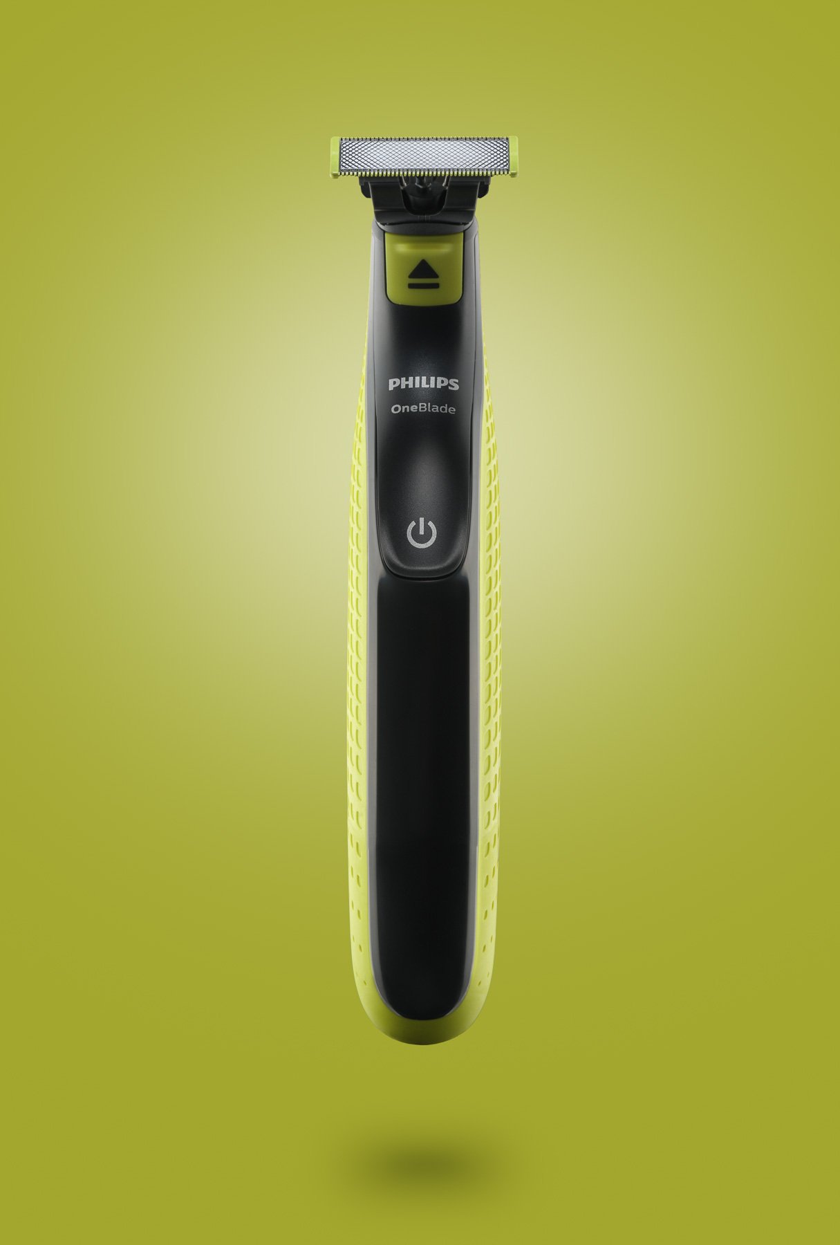 A Philips OneBlade electric grooming shaver with a yellow and black design on a yellow background.