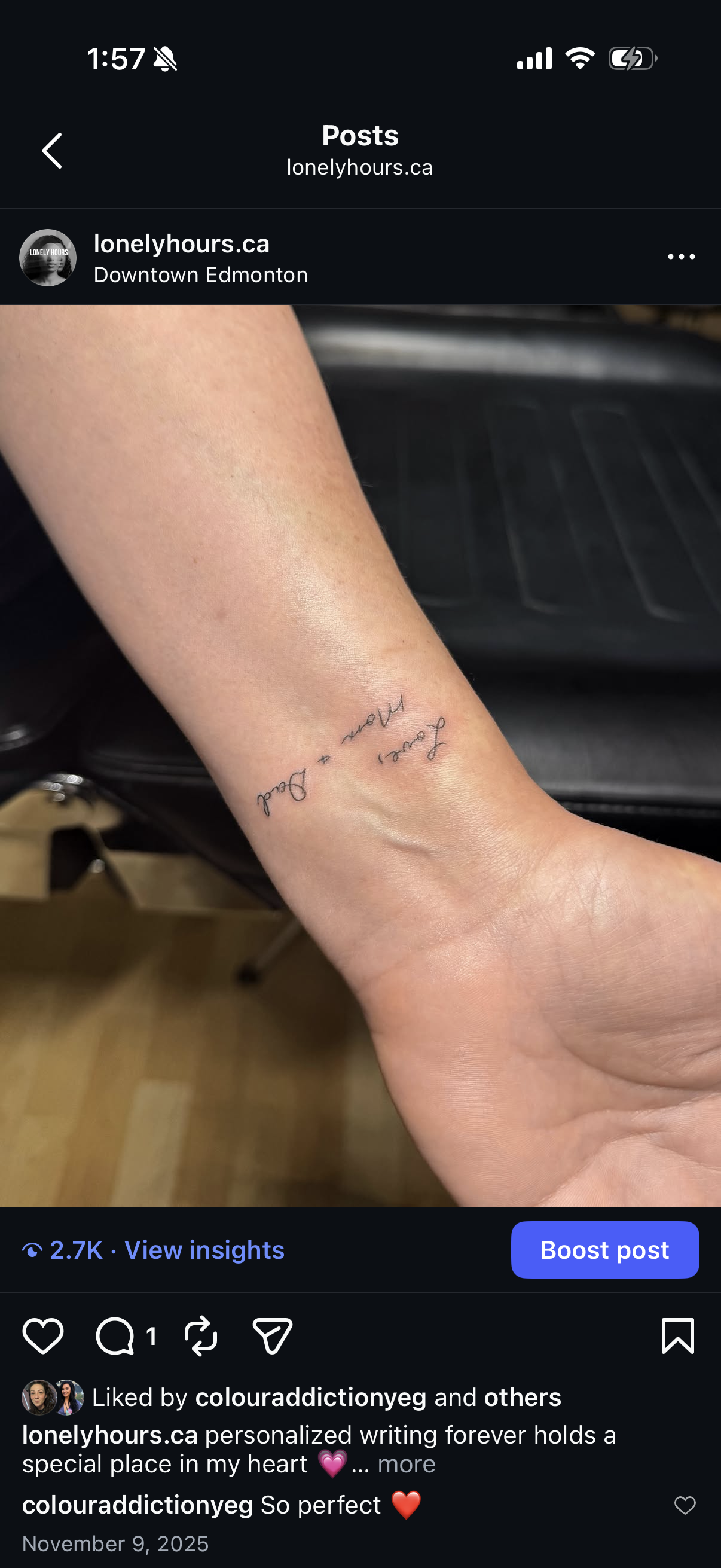 Close-up of a person's forearm showing a delicate tattoo with the words 'fear + pain' written in cursive script.
