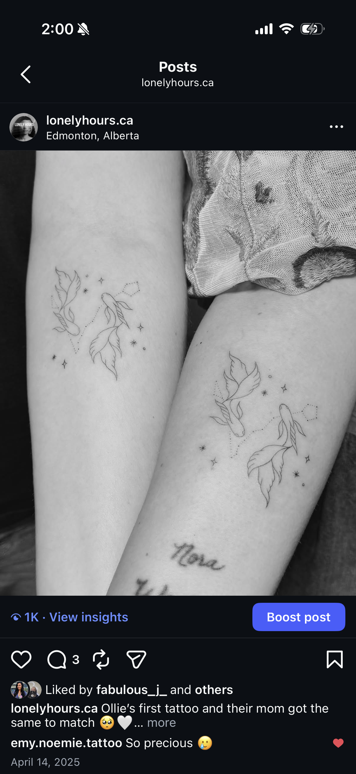 Black and white photo of two people showing their matching tattoos of koi fish surrounded by stars and dots on their thighs.