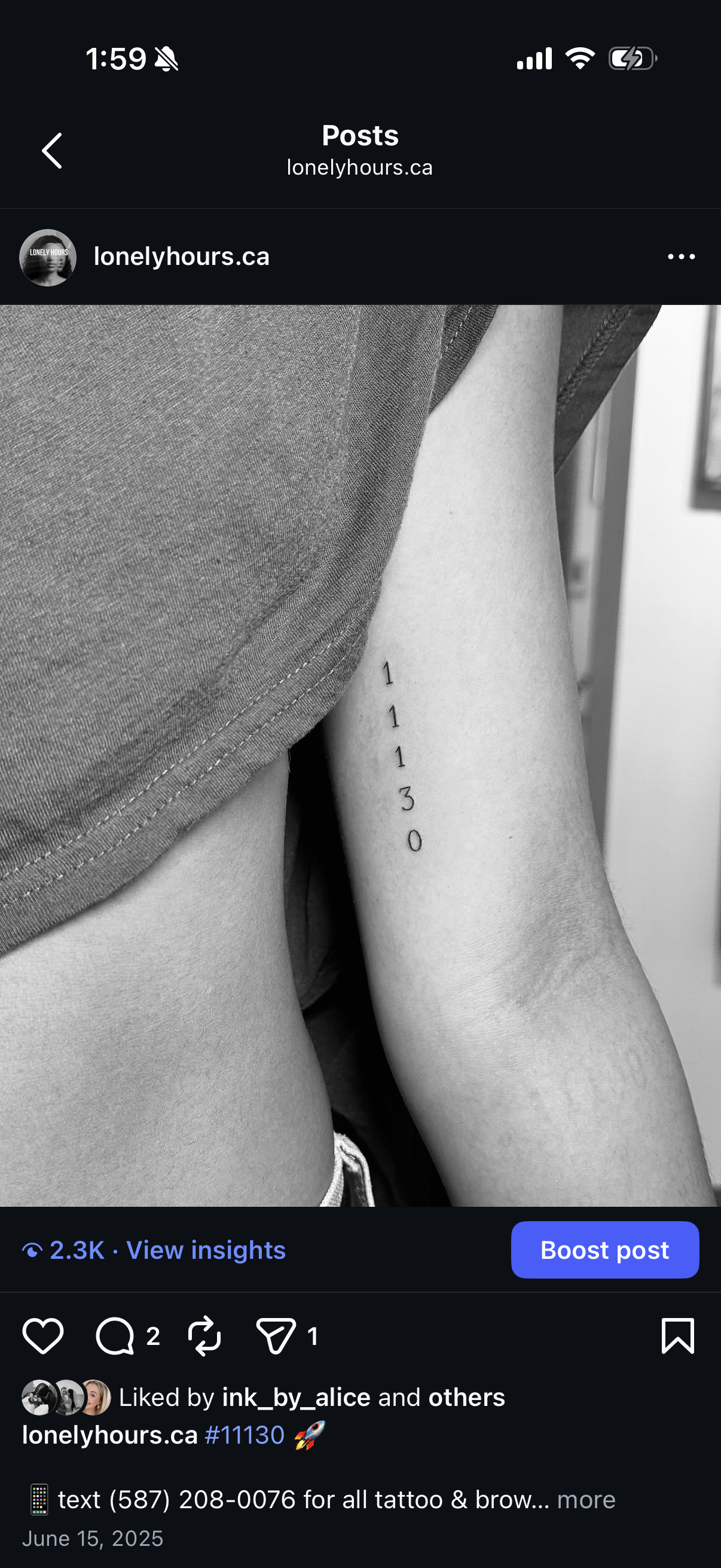 Black and white photo showing a person's arm with a tattoo of the number sequence '11130' in a vertical line, next to their gray T-shirt.