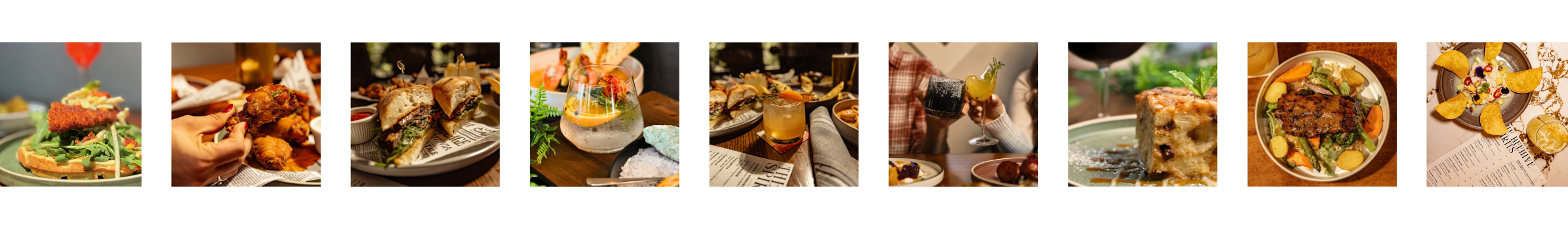 Assorted plates of food including salads, sandwiches, drinks, and desserts on tables in a restaurant setting.