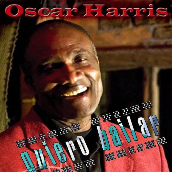 Afbeelding van een glimlachende man met een rode jas, met tekst "Oscar Harris" bovenaan en "quiero bailar" eronder, met een muzikale achtergrond.