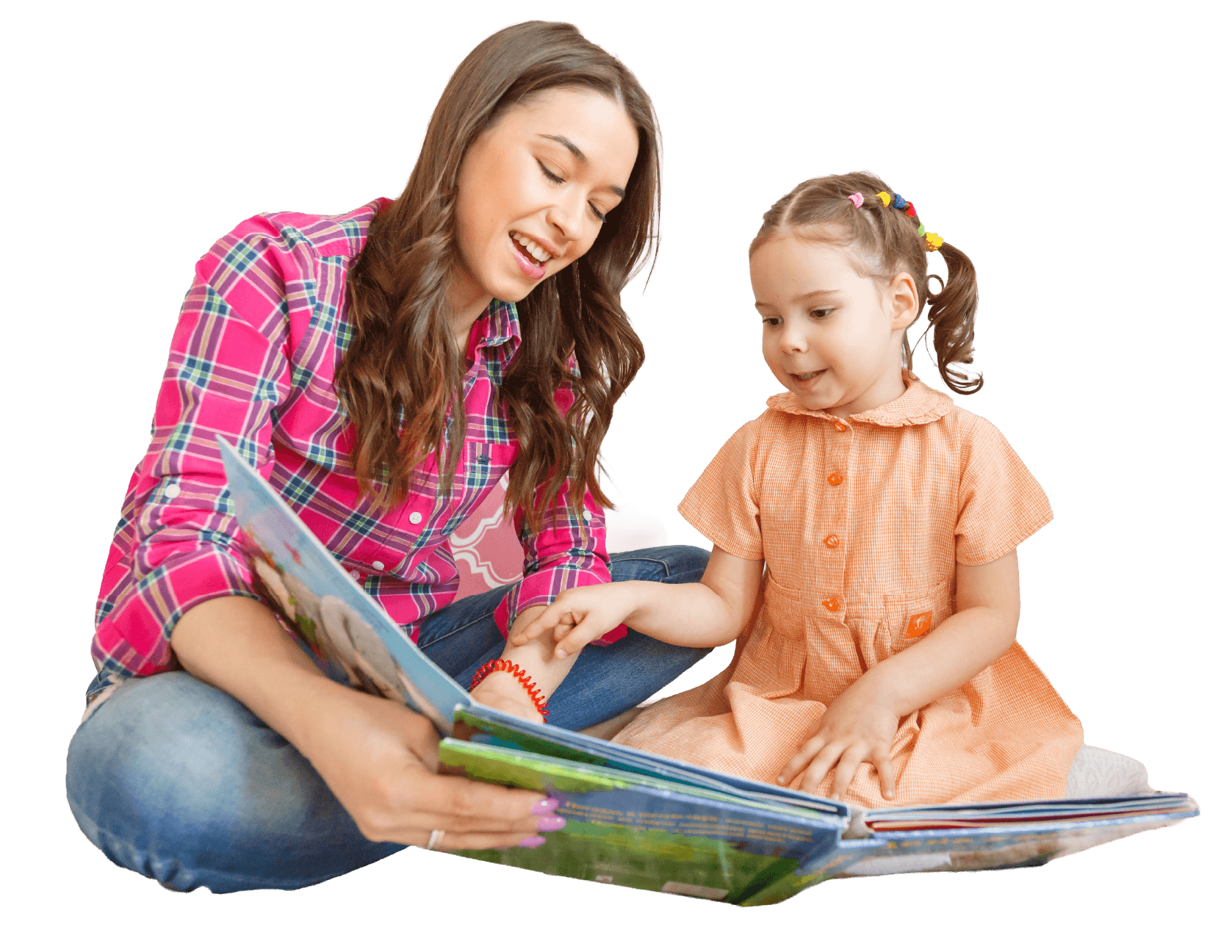 A young woman and a little girl sitting on the floor, reading a colorful book together. The woman is wearing a pink plaid shirt, and the girl is in an orange dress with a ruffled collar, her hair styled in pigtails decorated with colorful beads.